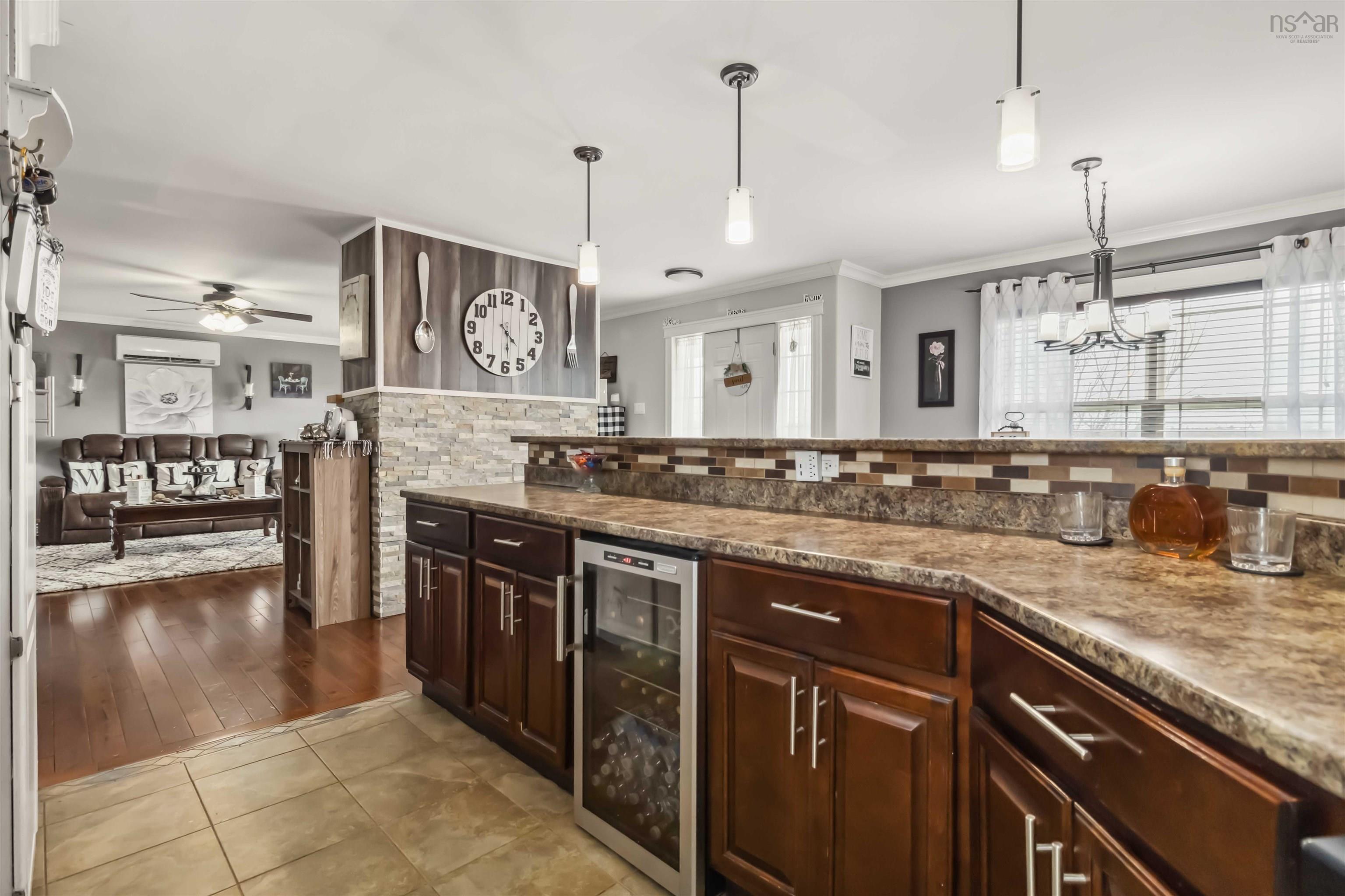 Kitchen with wine cooler, ornamental molding, backsplash, a ceiling fan, and tile patterned floors