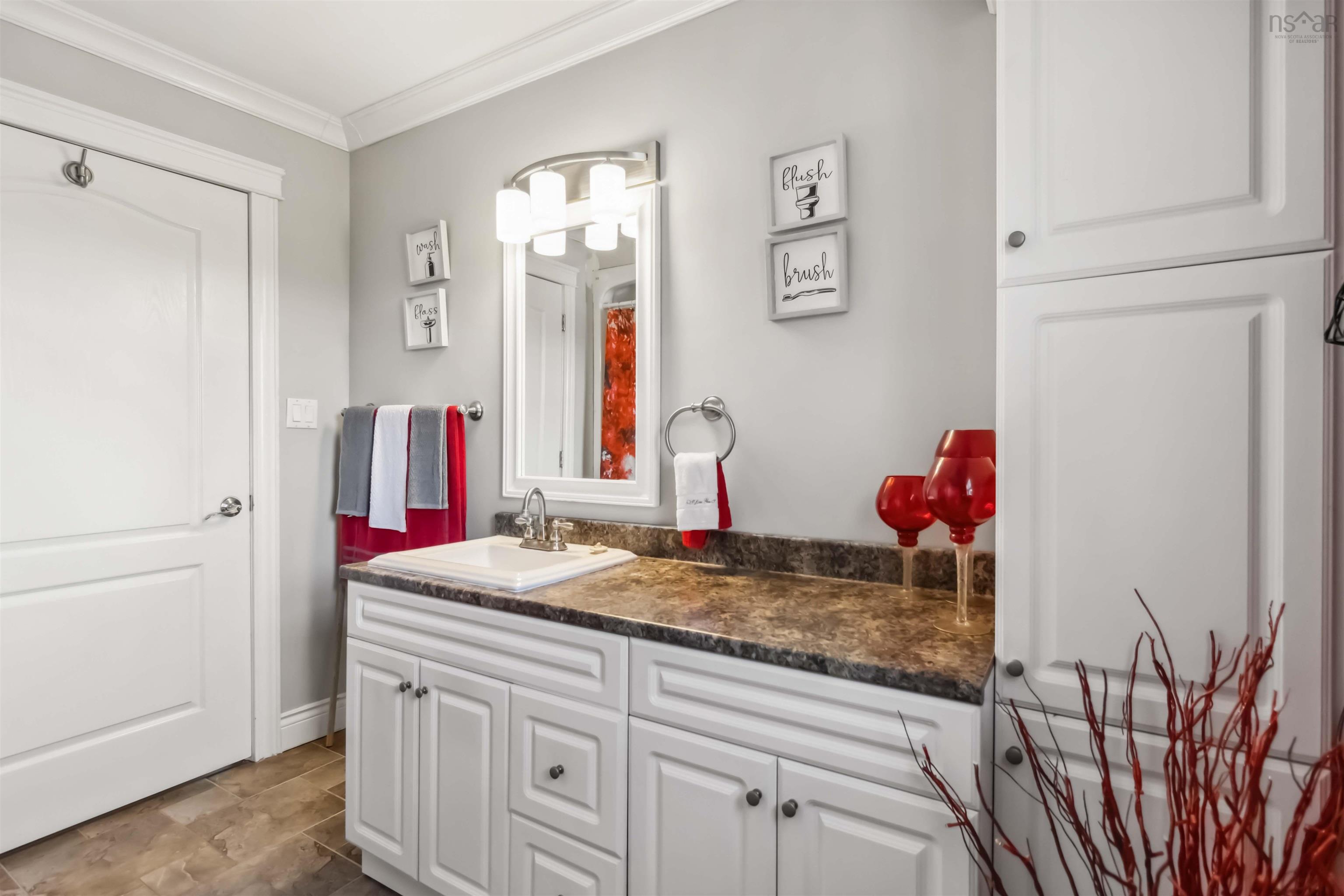 Bathroom with ornamental molding and vanity