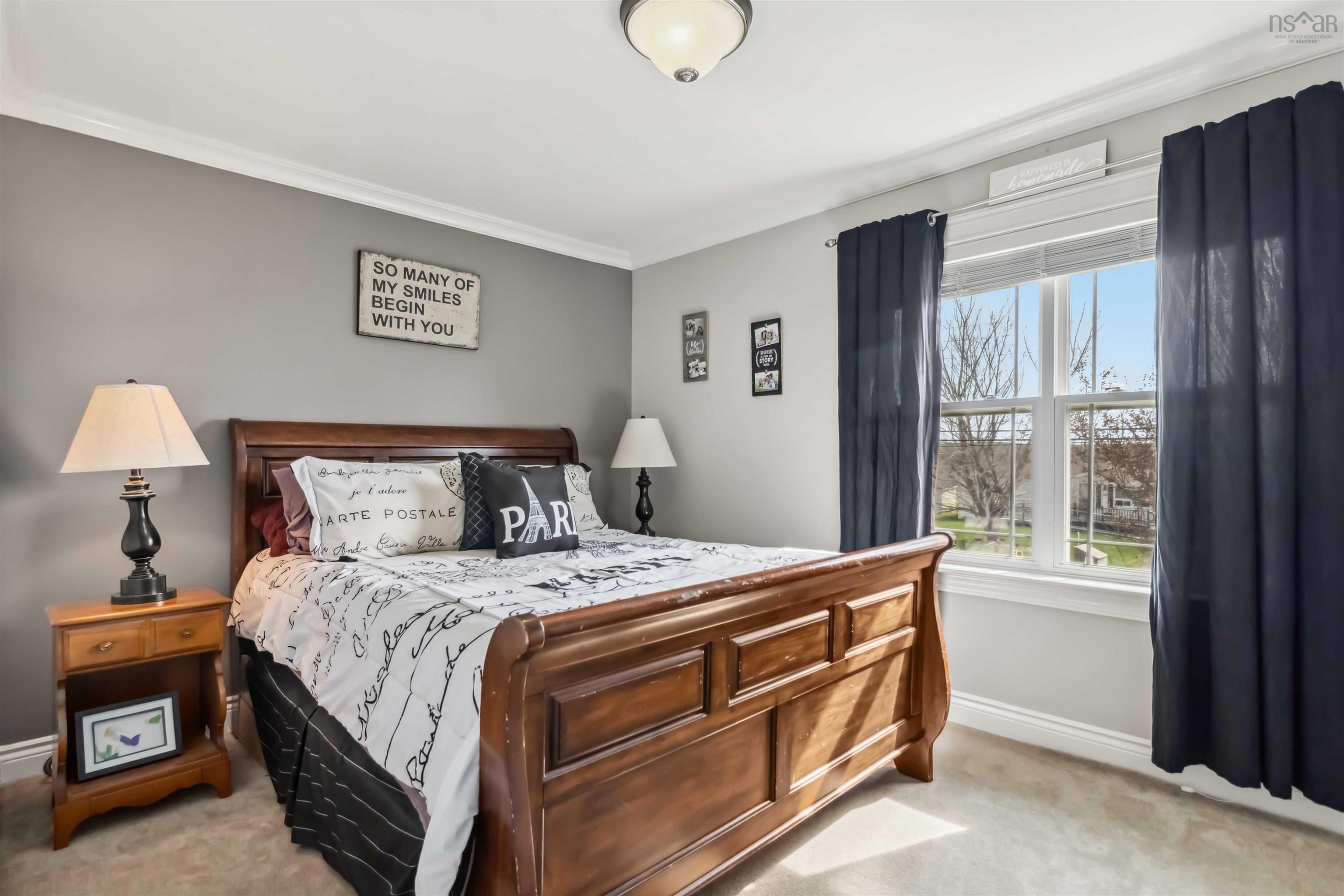 Bedroom featuring light colored carpet, baseboards, and crown molding