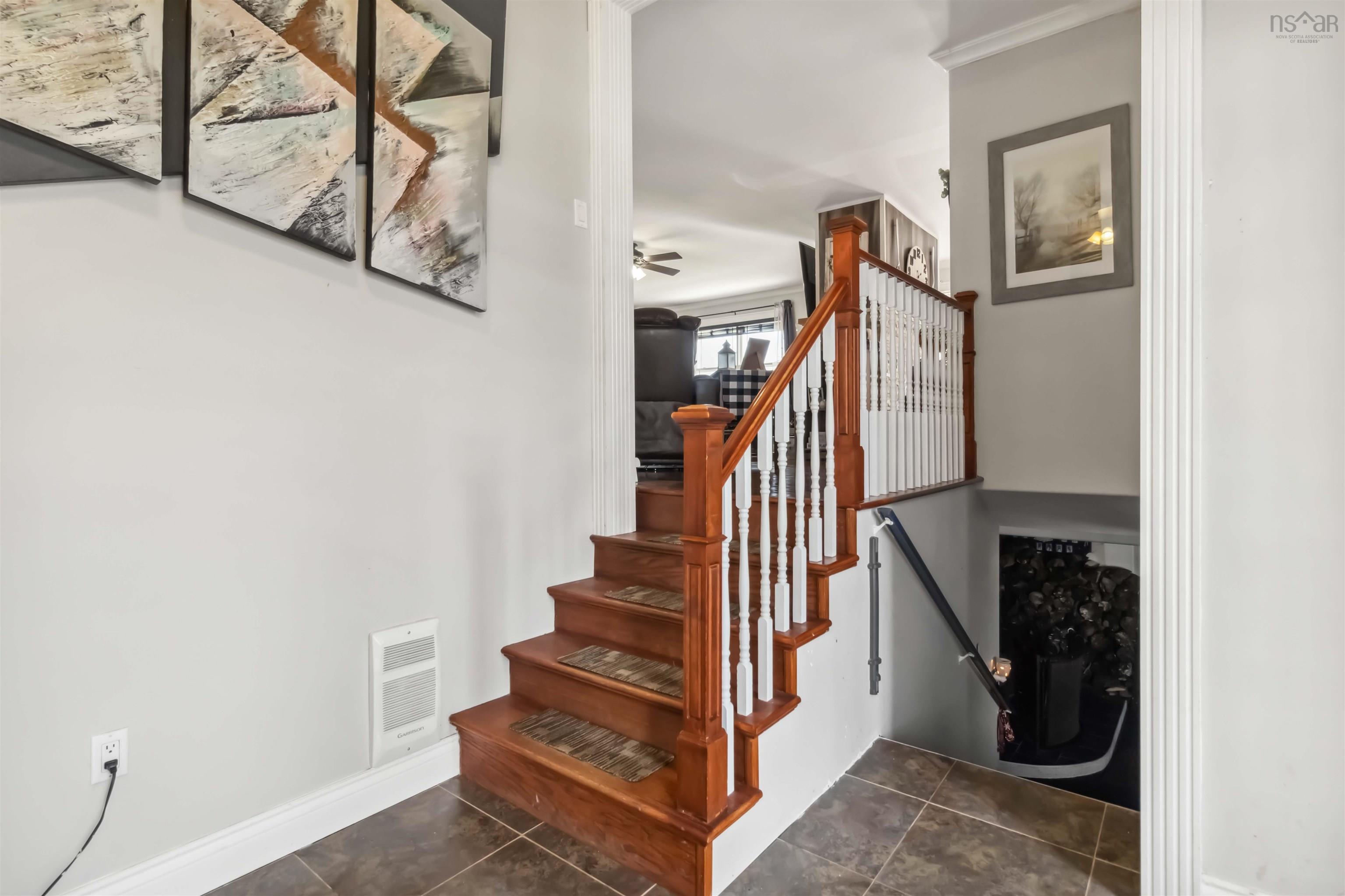Staircase featuring ceiling fan, tile patterned flooring, and baseboards