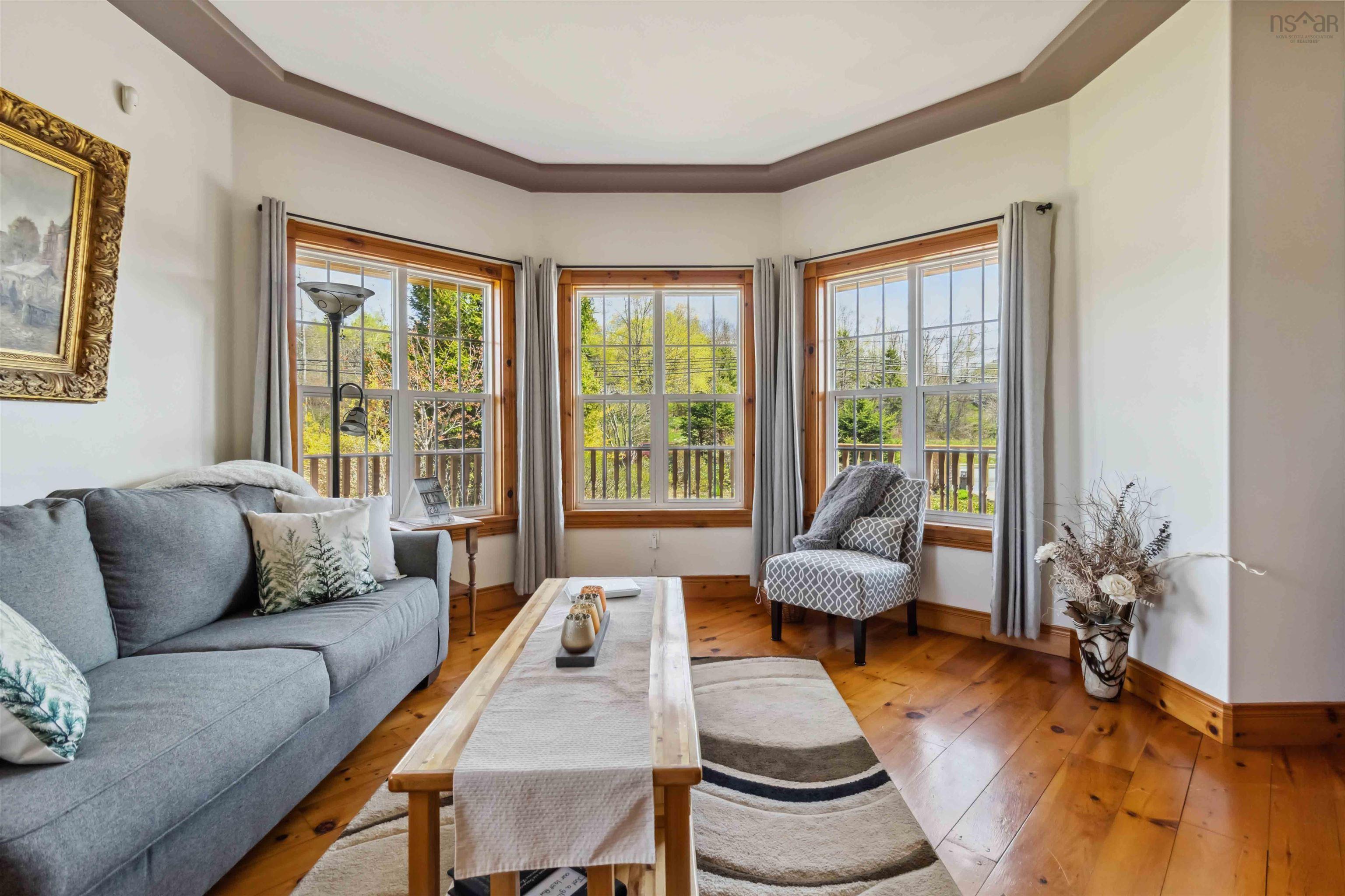 Living area featuring plenty of natural light, hardwood / wood-style floors, and baseboards