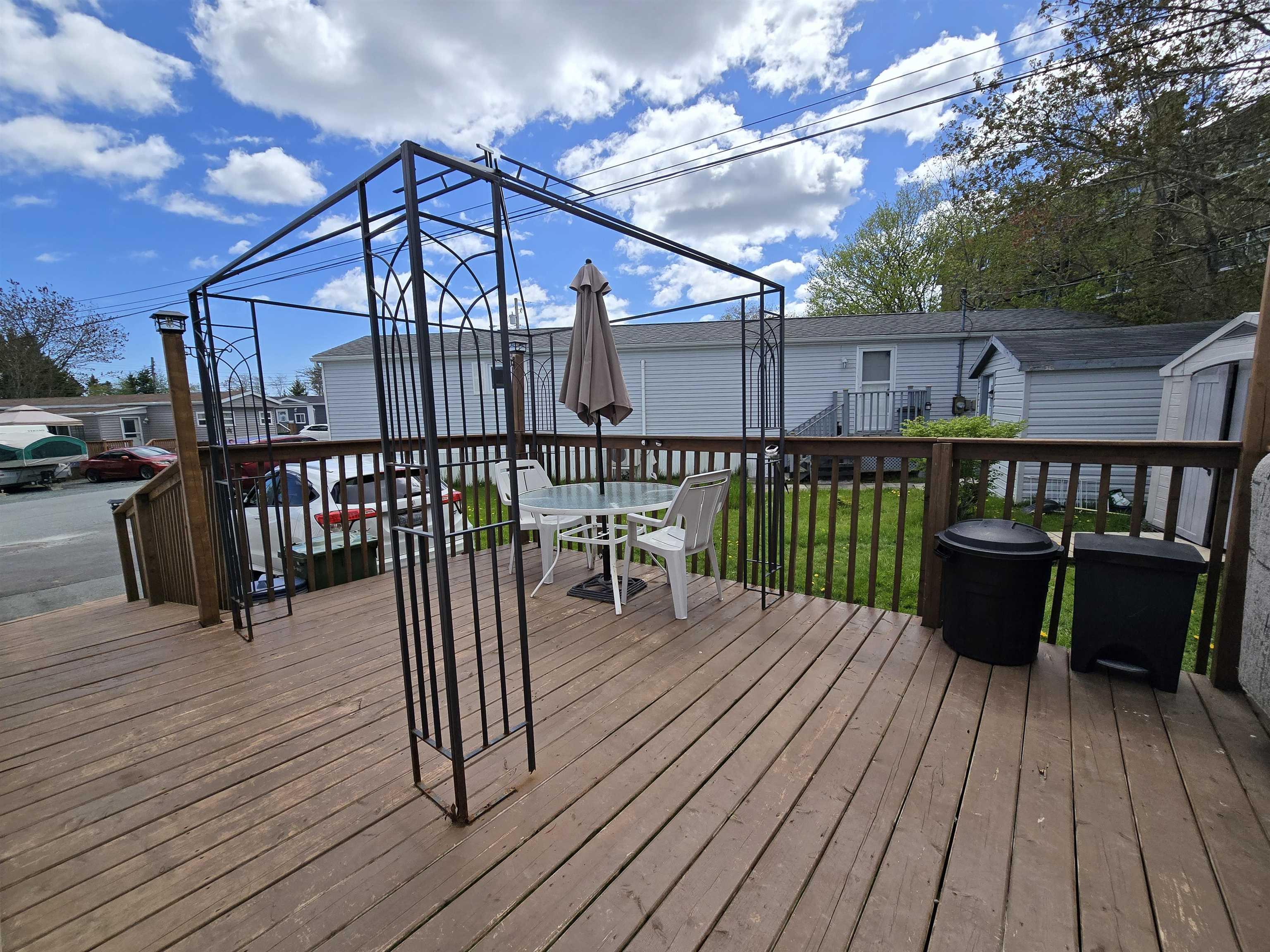 Deck with outdoor dining area and an outbuilding