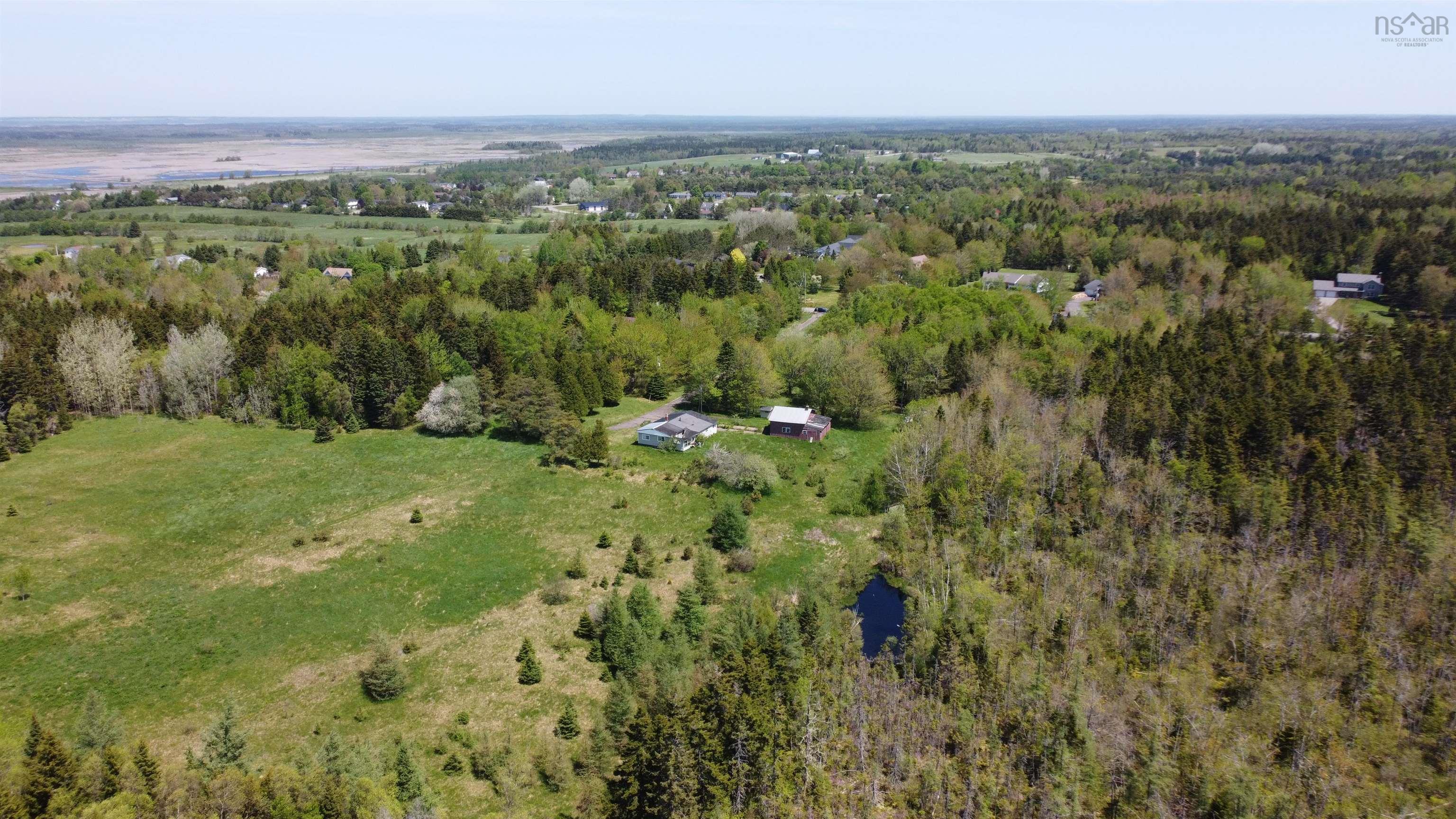 View of property location featuring a forest