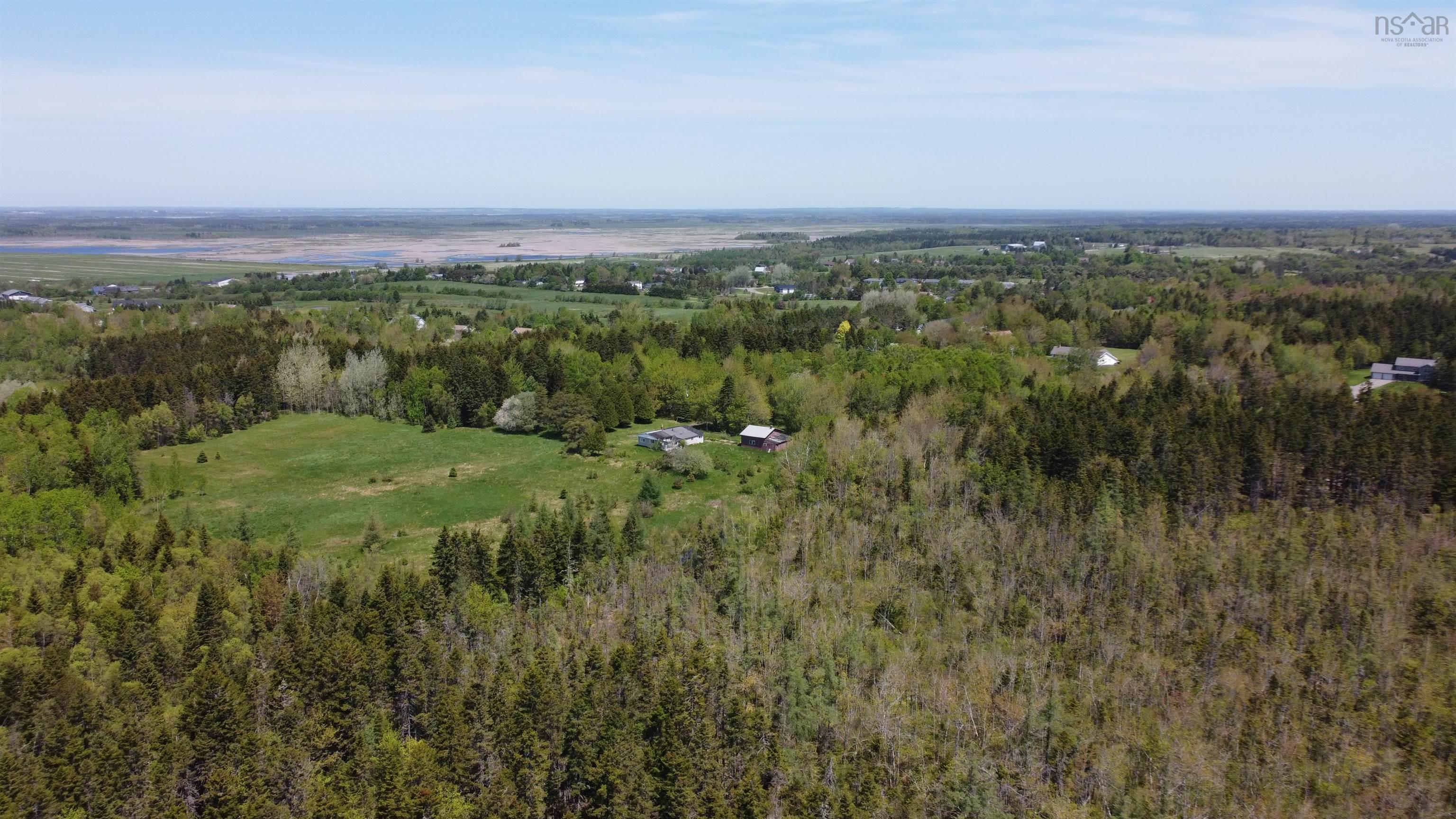 Aerial view of property's location featuring a forest
