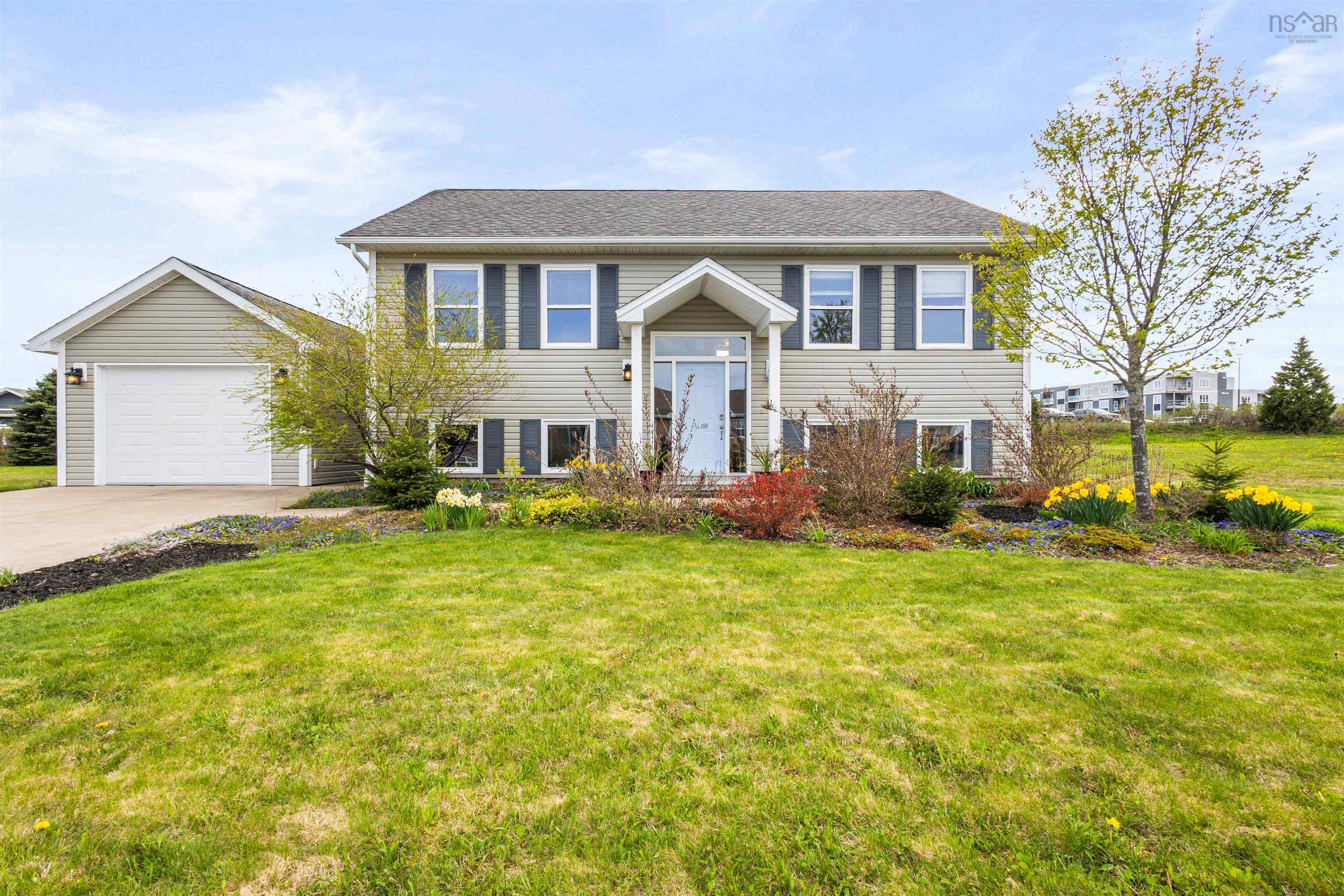 Bi-level home with a front lawn and concrete driveway