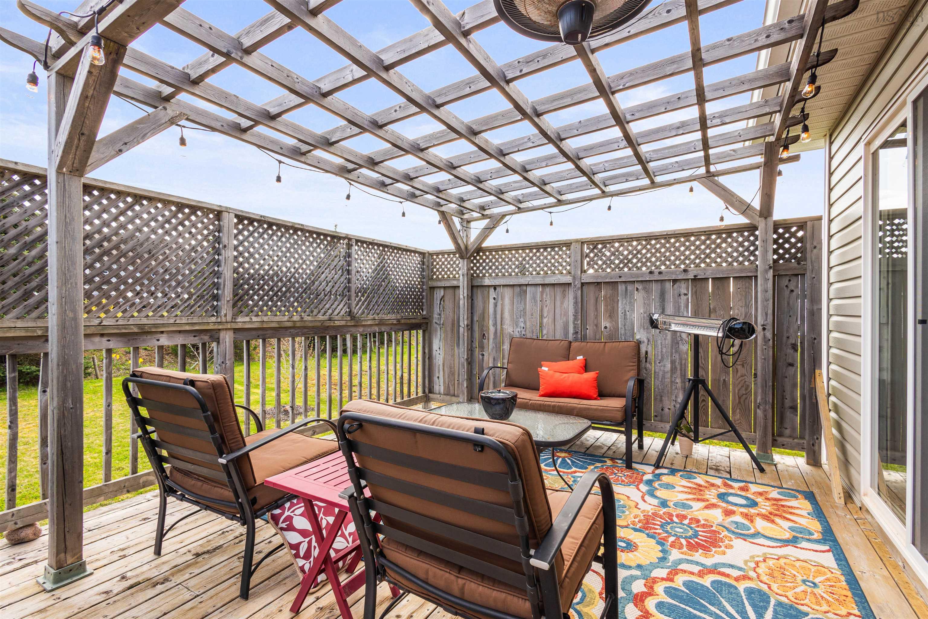 Wooden deck with a pergola and outdoor lounge area