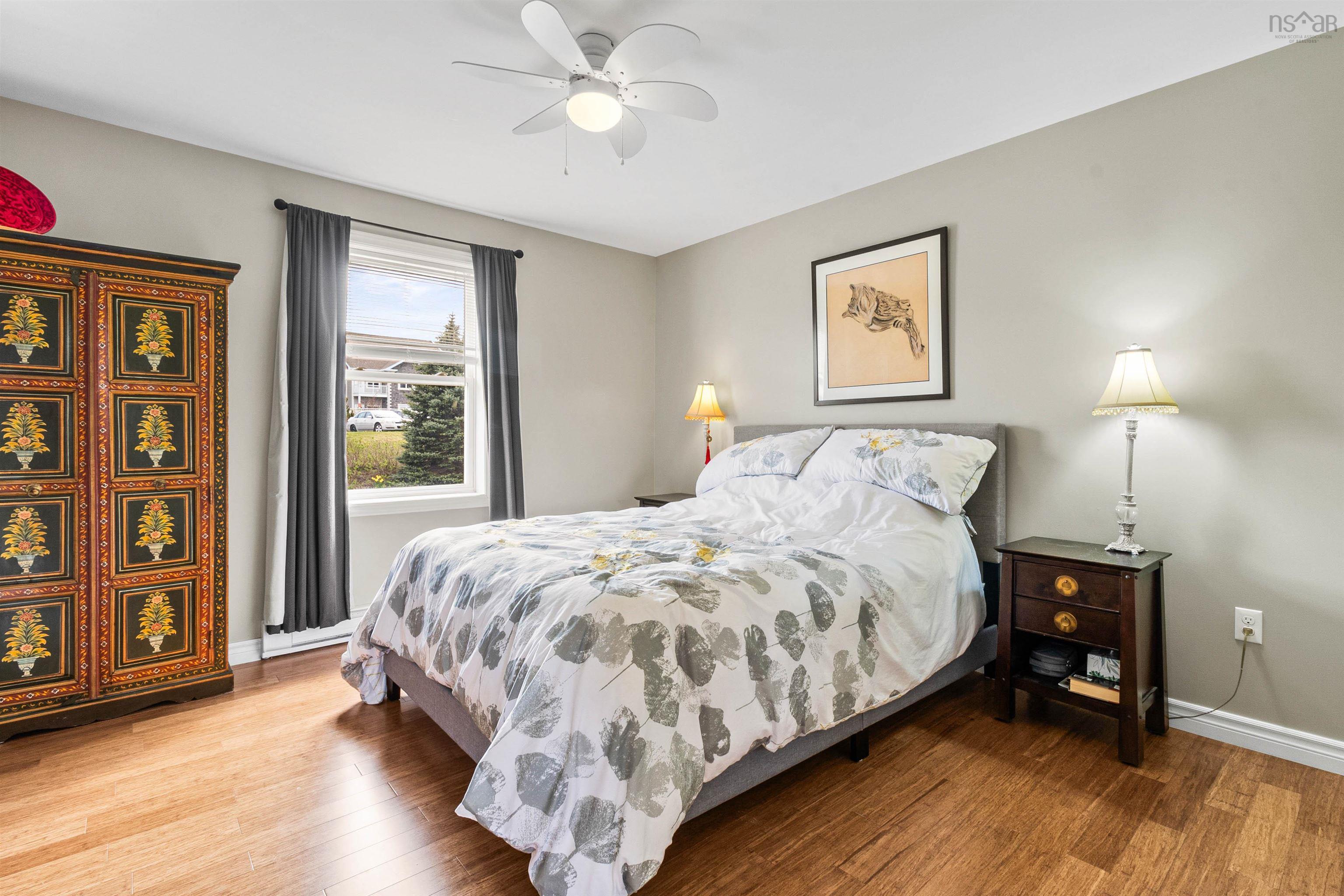 Bedroom featuring wood finished floors, baseboards, and ceiling fan