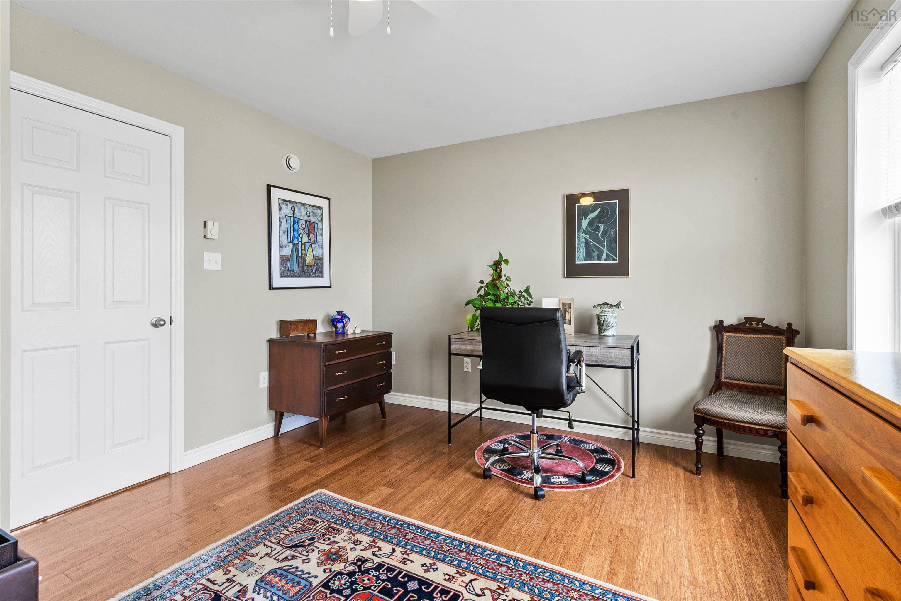 Office area with wood finished floors, baseboards, and ceiling fan