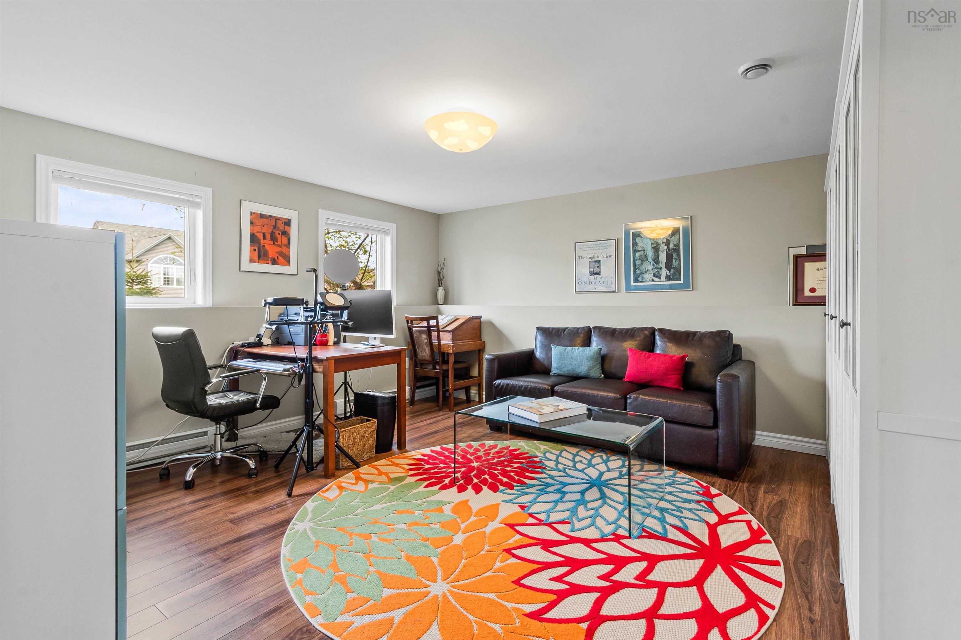 Office space featuring wood finished floors, baseboards, and a baseboard radiator