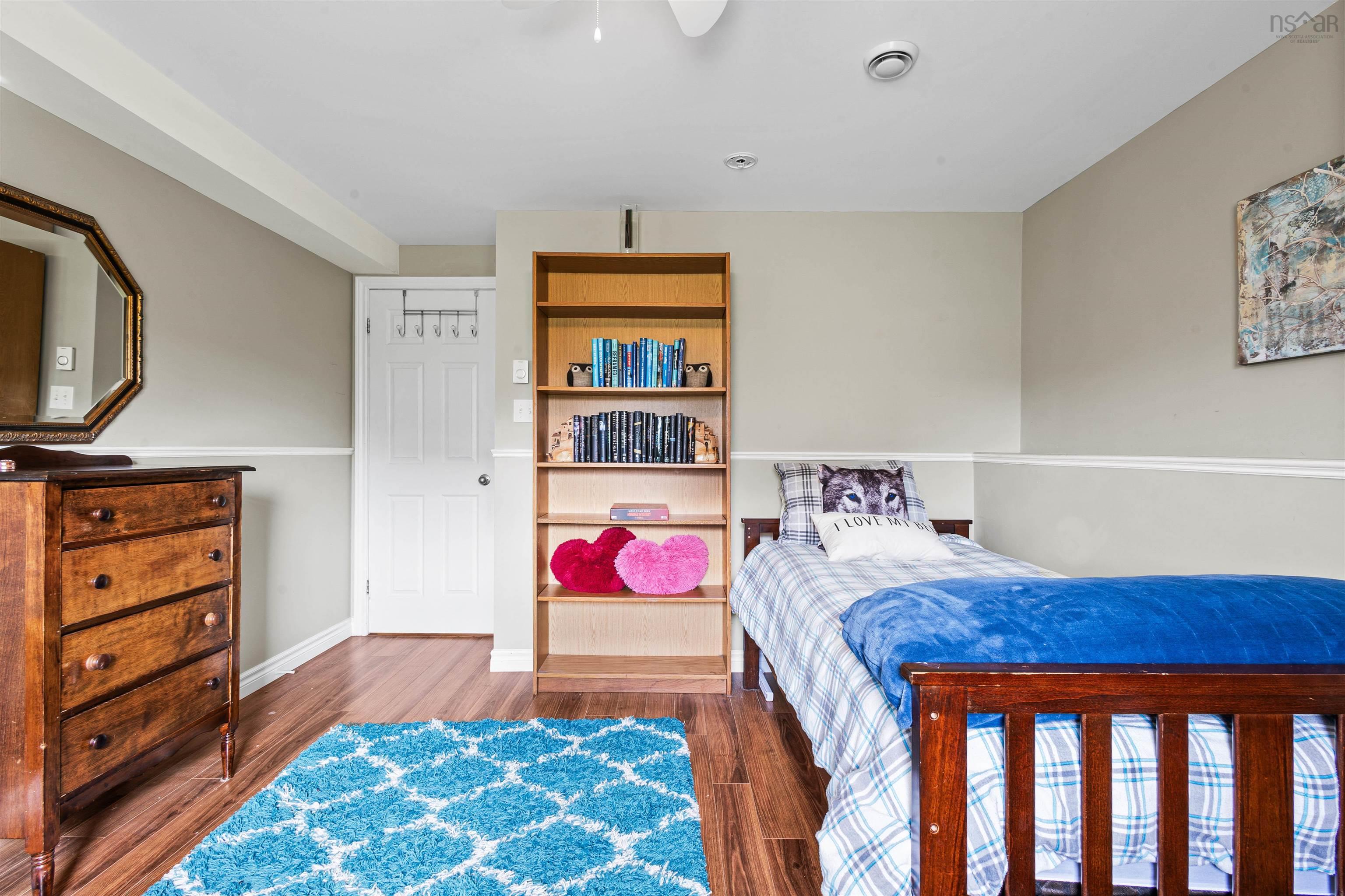 Bedroom with wood finished floors and baseboards