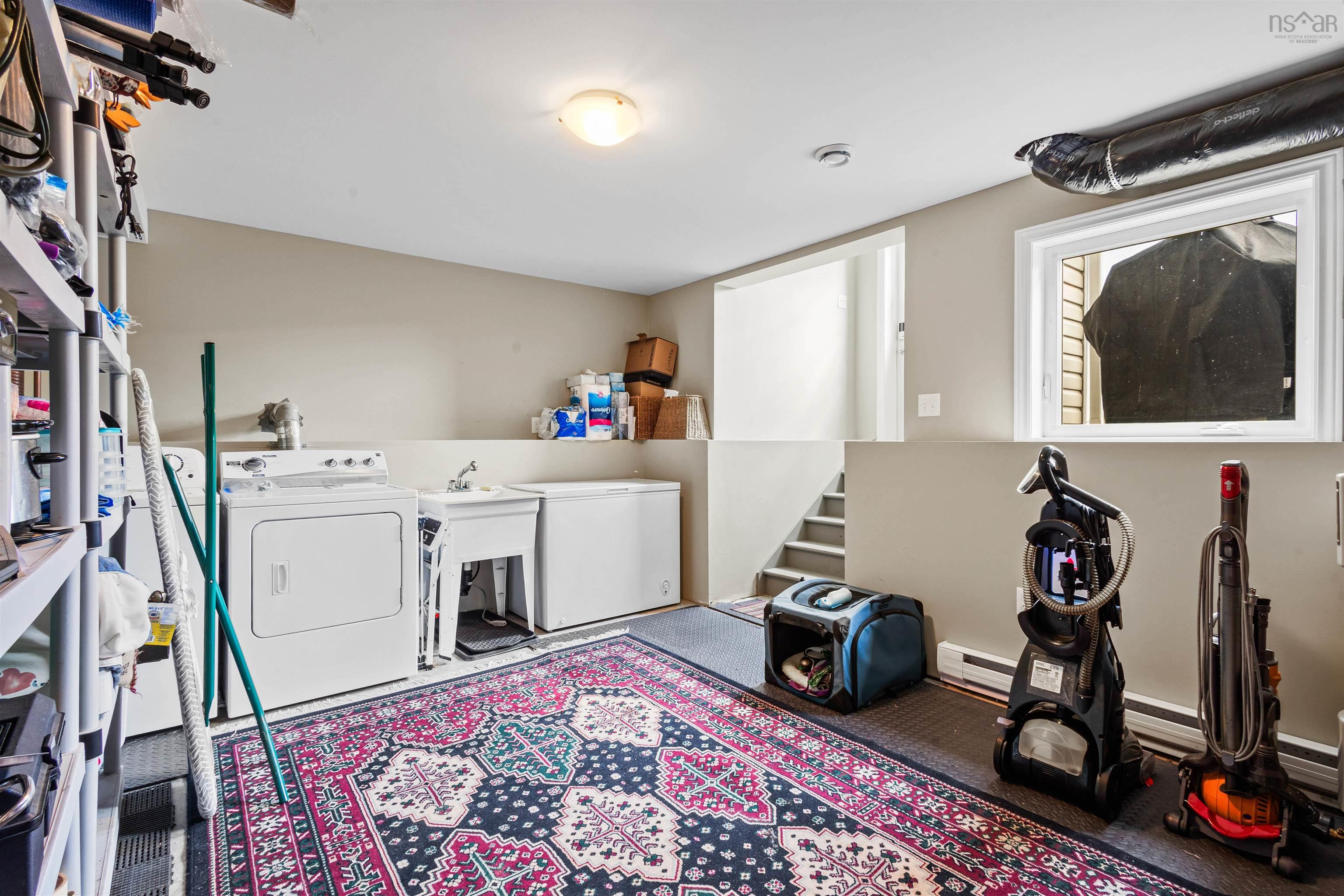 Washroom featuring washing machine and dryer and a baseboard heating unit