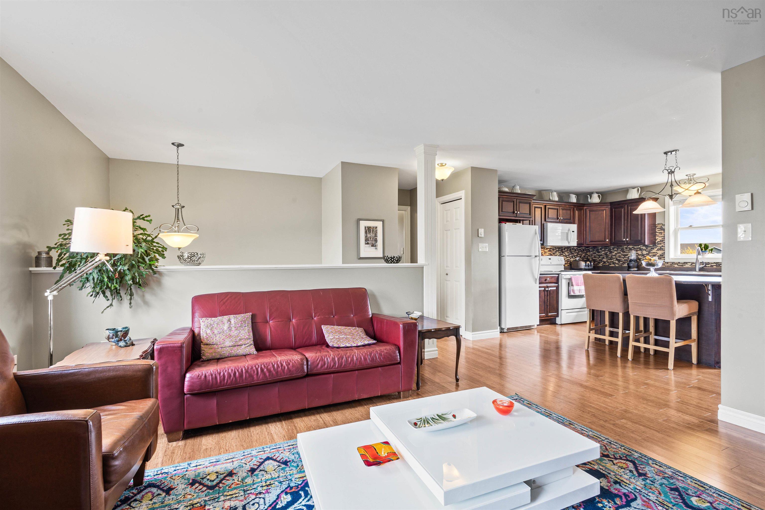 Living room featuring light wood-style floors and baseboards