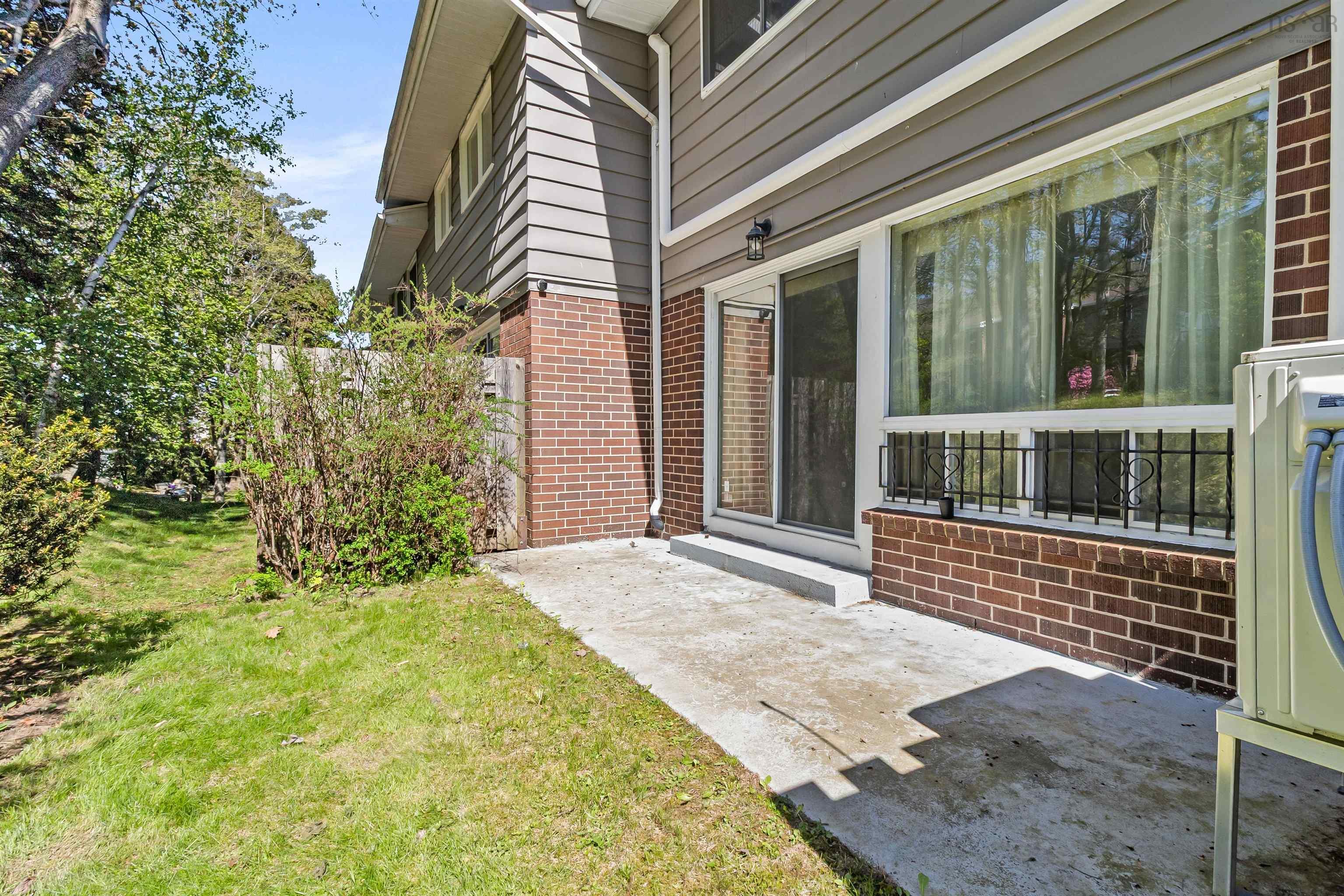 View of grassy yard with a patio area