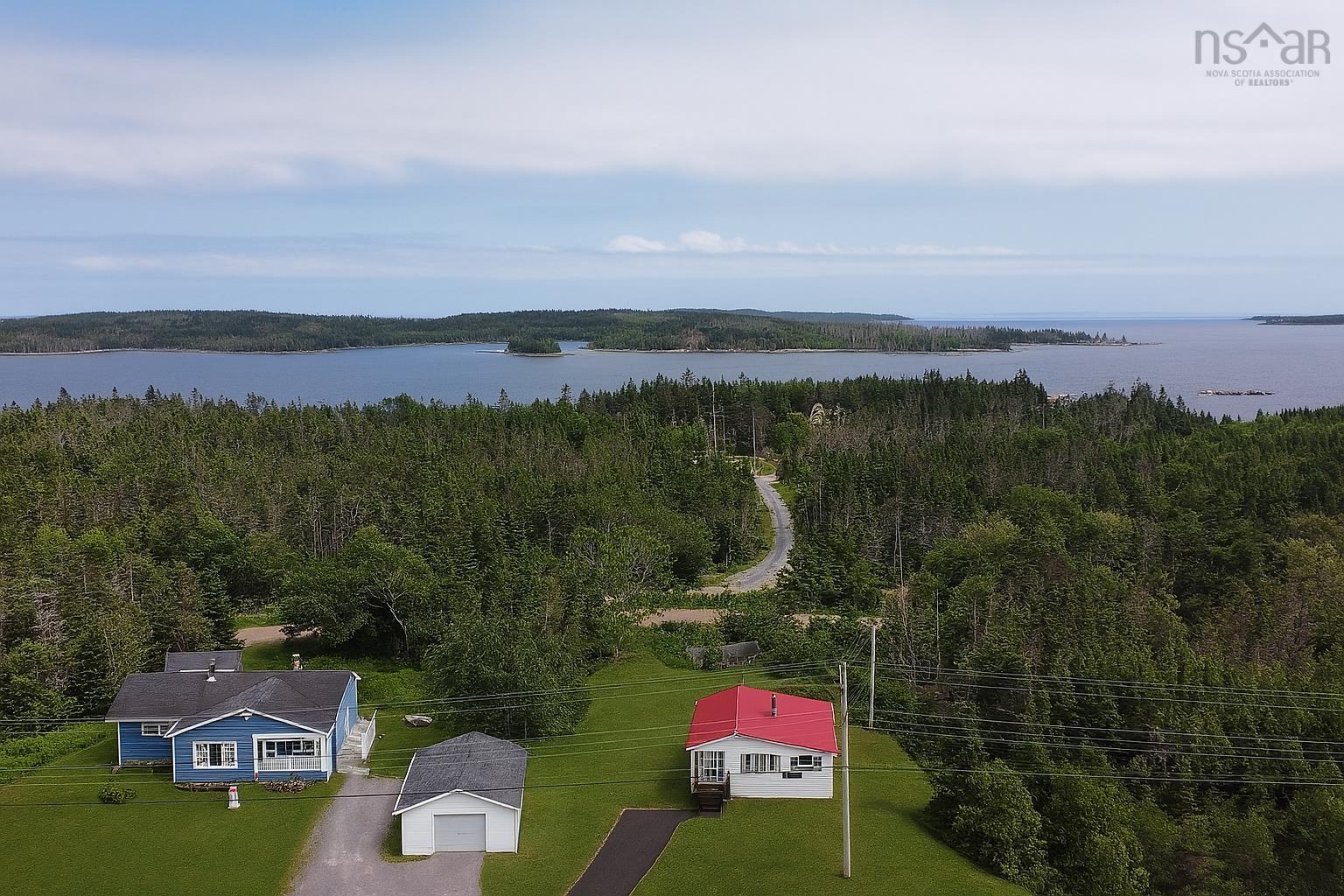 Aerial view of property and surrounding area featuring a nearby body of water