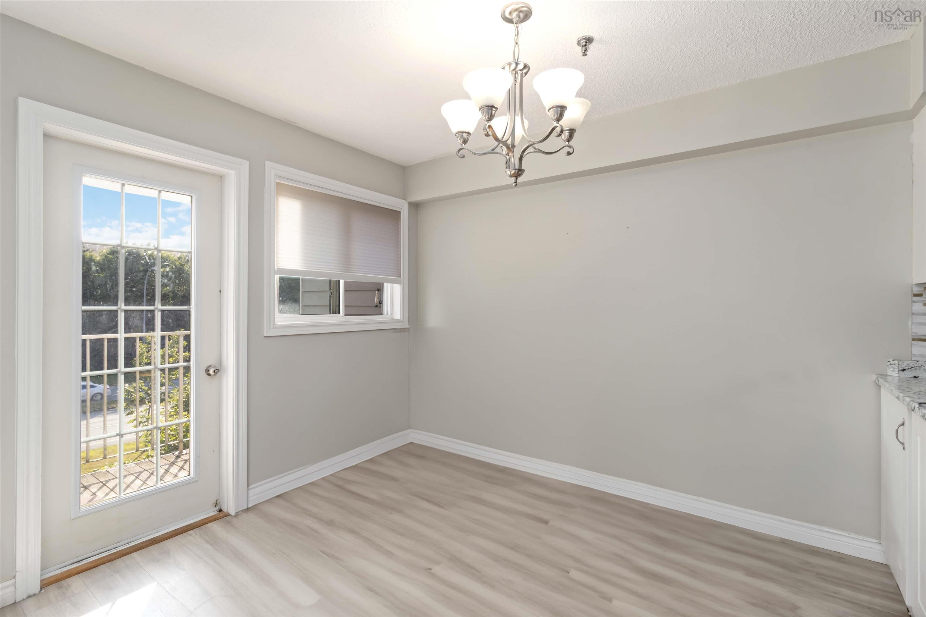 Unfurnished dining area with a chandelier and light wood finished floors