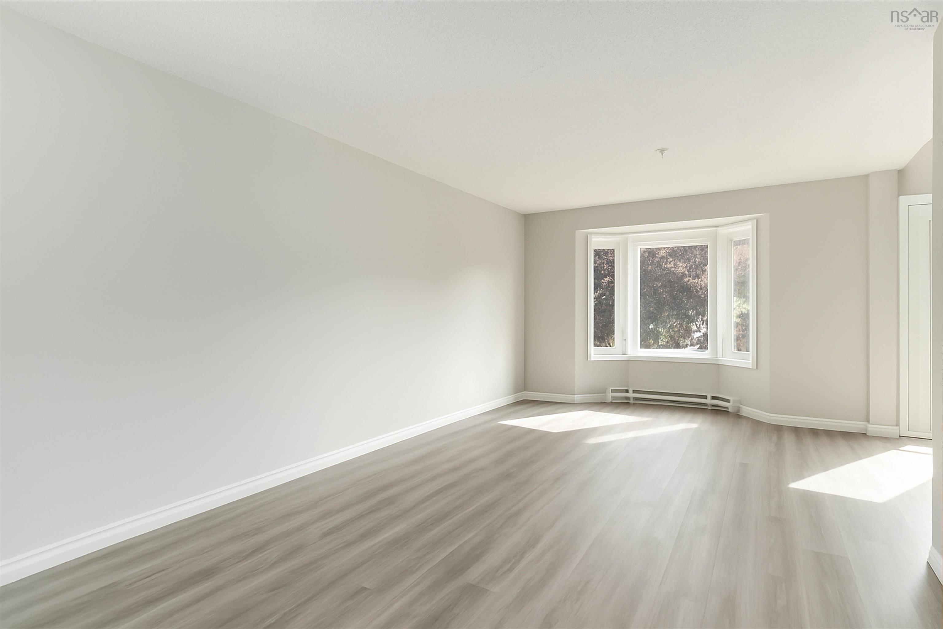 Unfurnished room featuring light wood-style floors and a baseboard radiator
