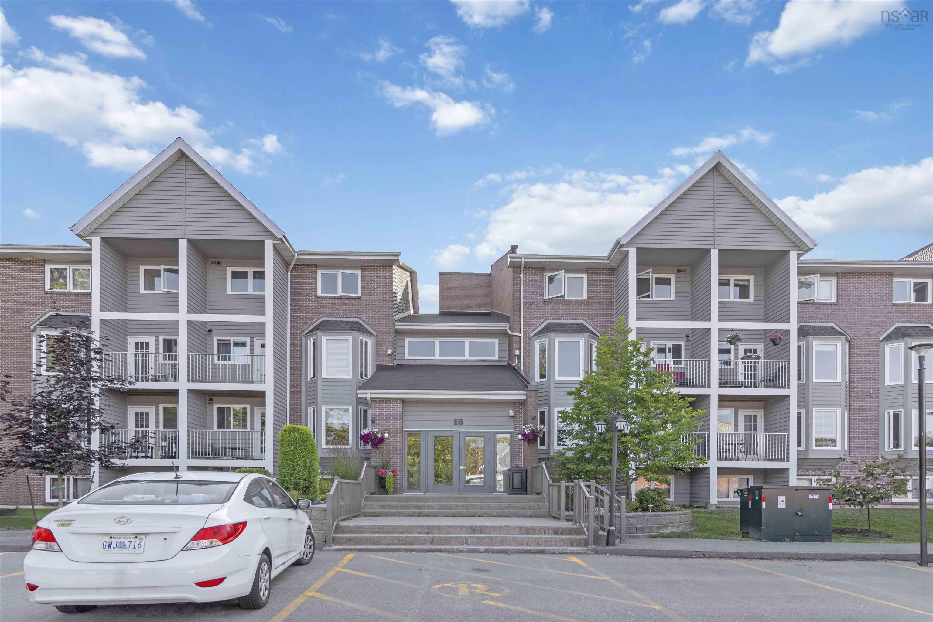 View of property featuring uncovered parking and a residential view