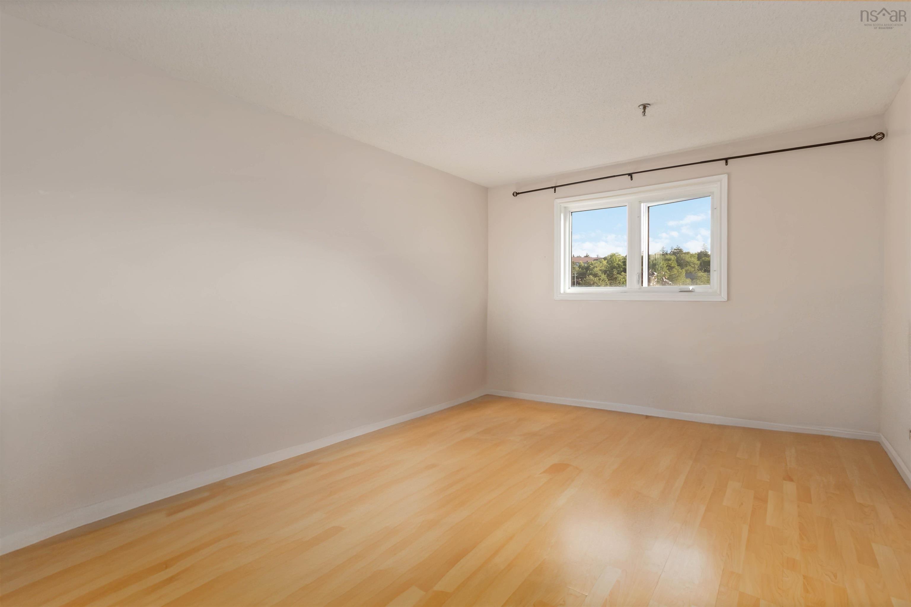 Empty room with baseboards and wood finished floors