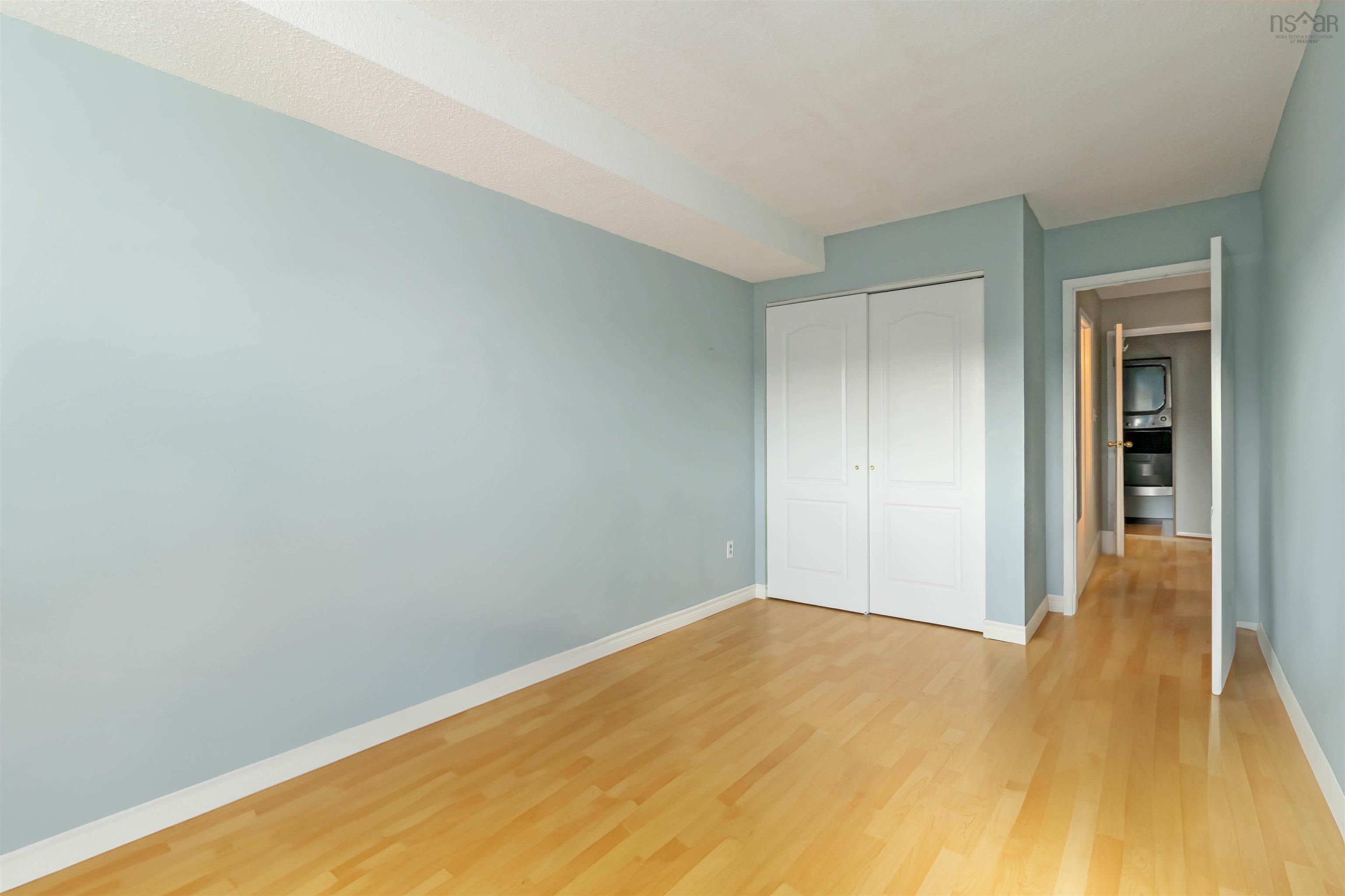 Unfurnished bedroom with light wood finished floors and a closet