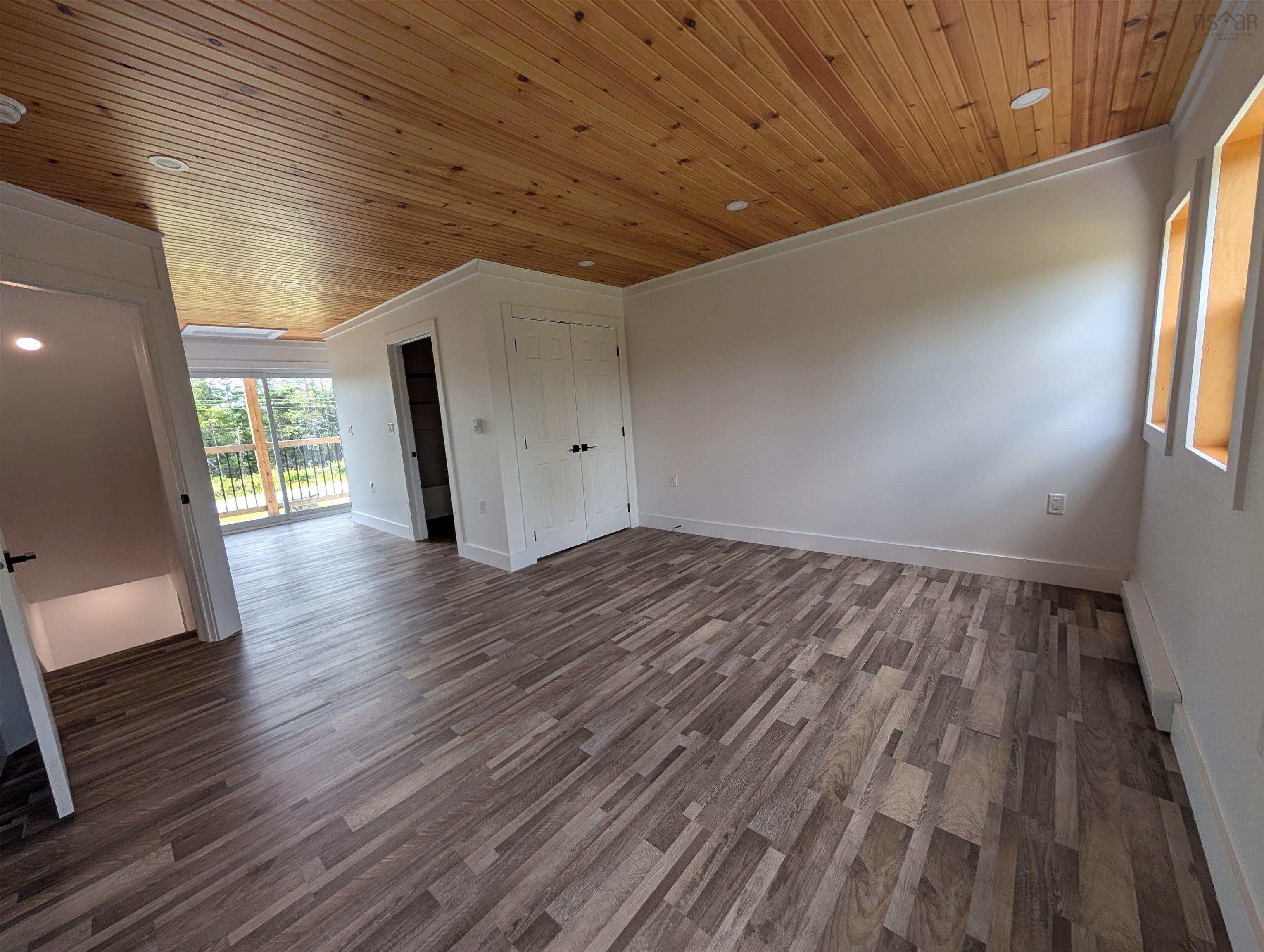 Spare room with wood ceiling, dark wood-style floors, a baseboard heating unit, crown molding, and recessed lighting