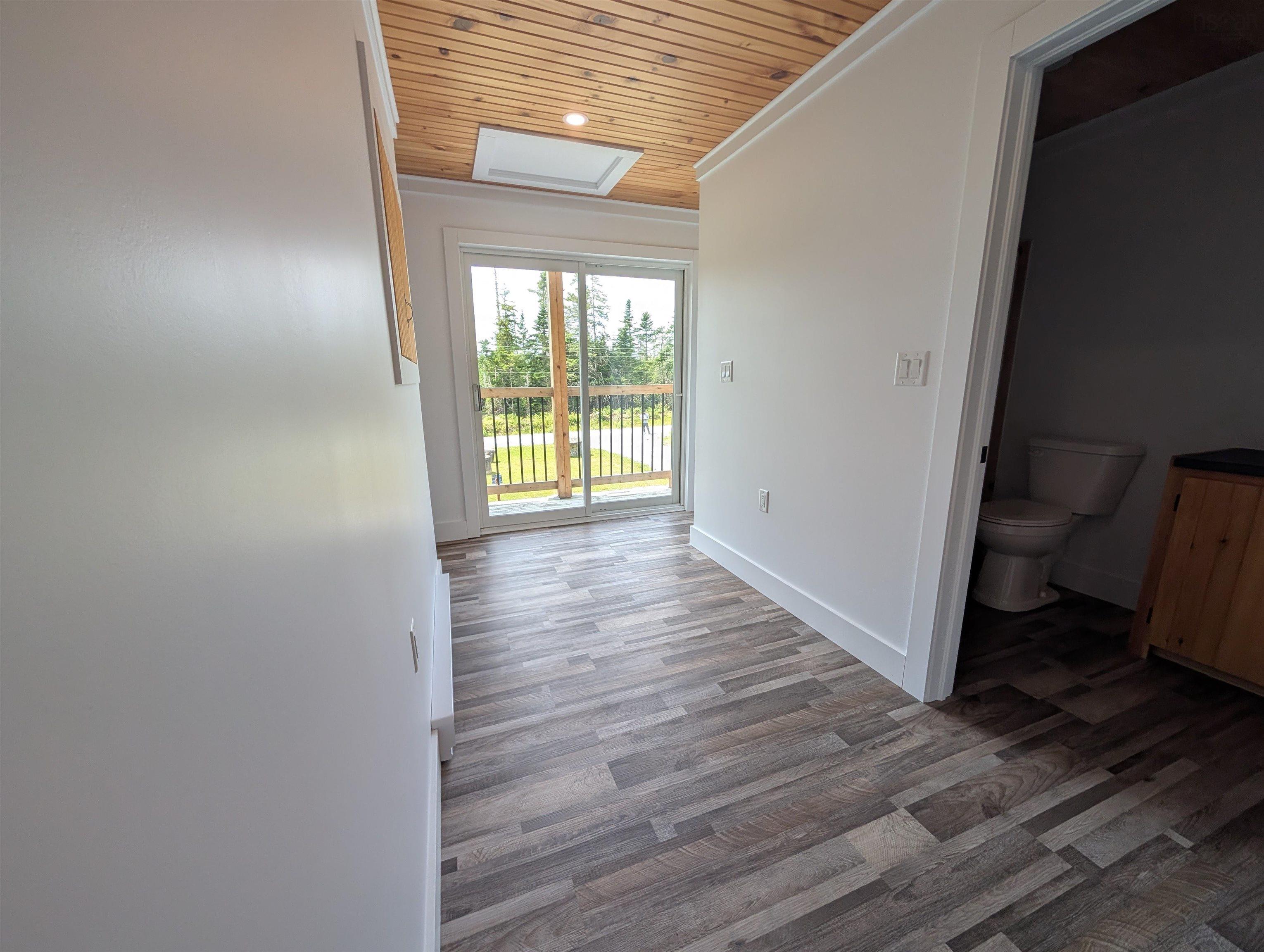 Hall featuring wood ceiling, wood finished floors, and crown molding