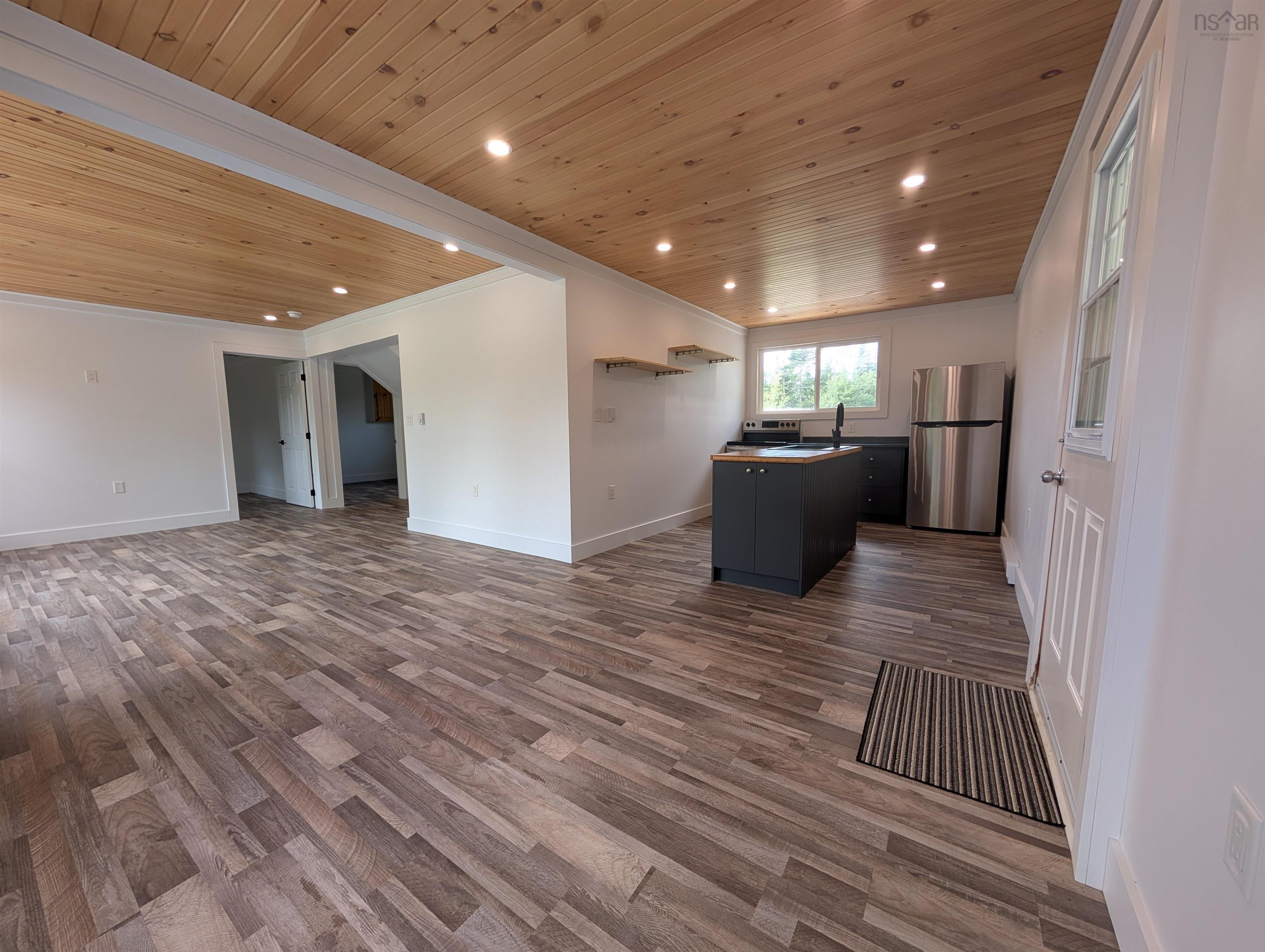 Unfurnished living room featuring wooden ceiling, dark wood-type flooring, recessed lighting, and crown molding
