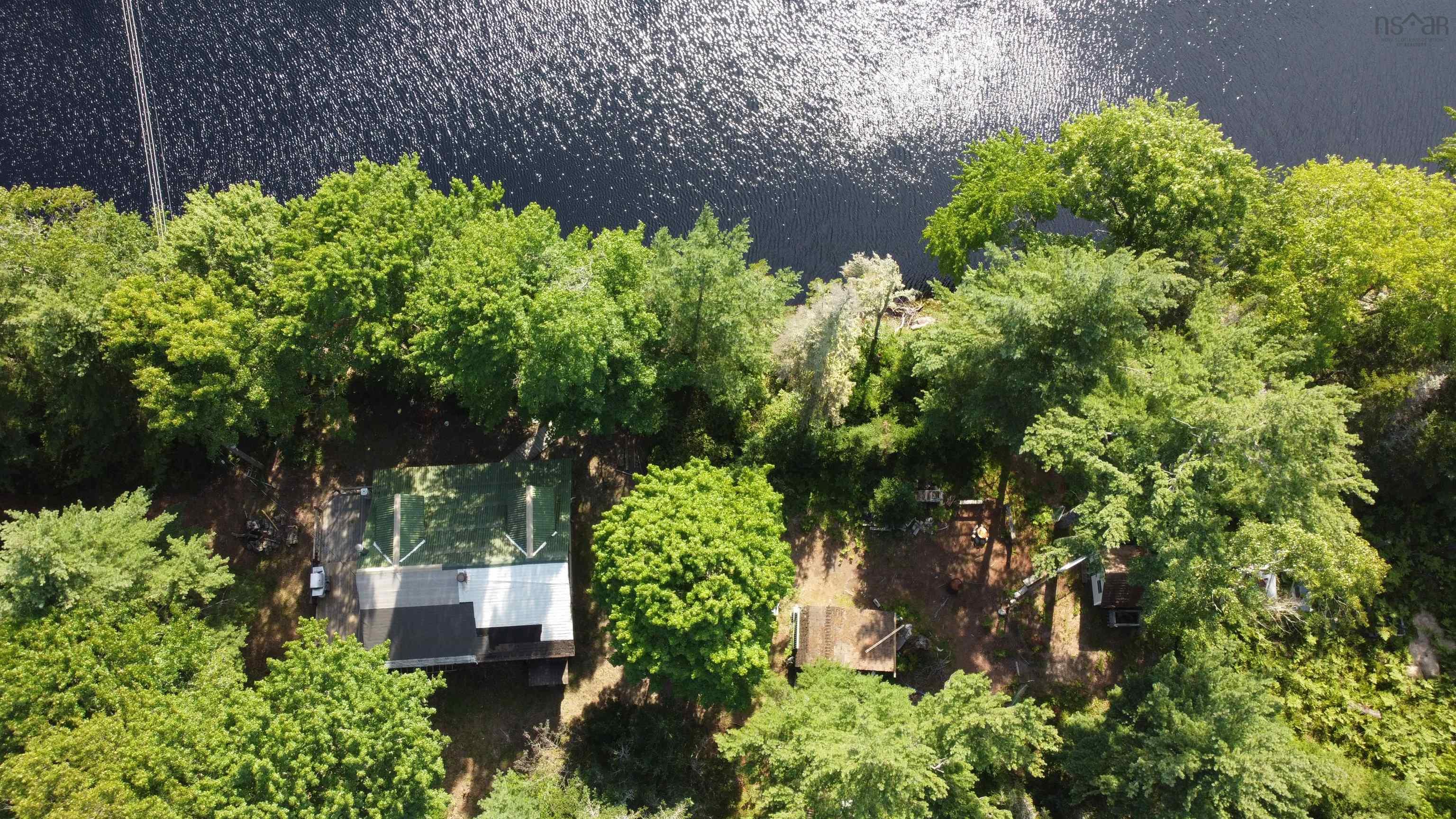Aerial view of property and surrounding area with a large body of water