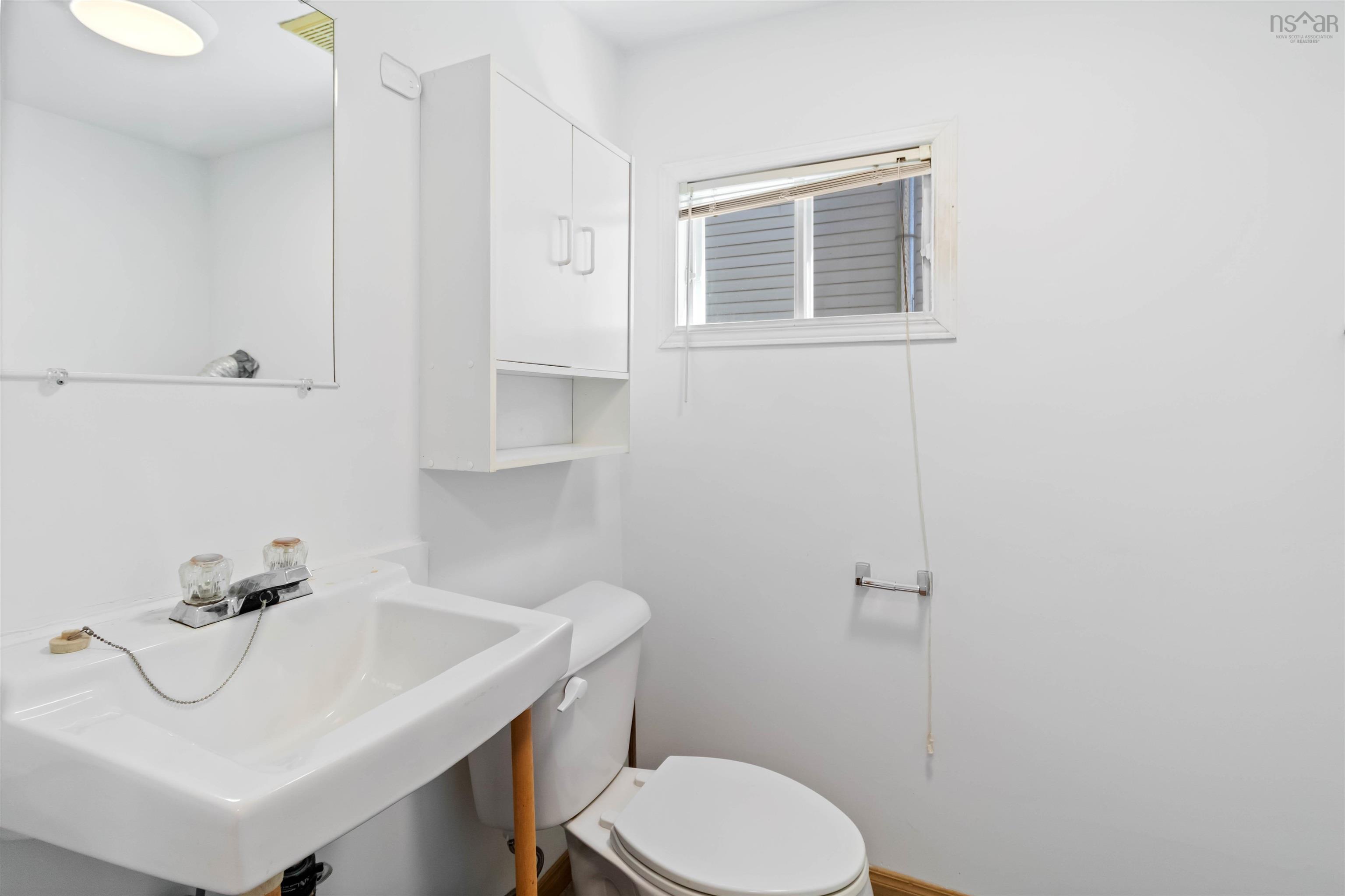 Half bath with a sink and toilet