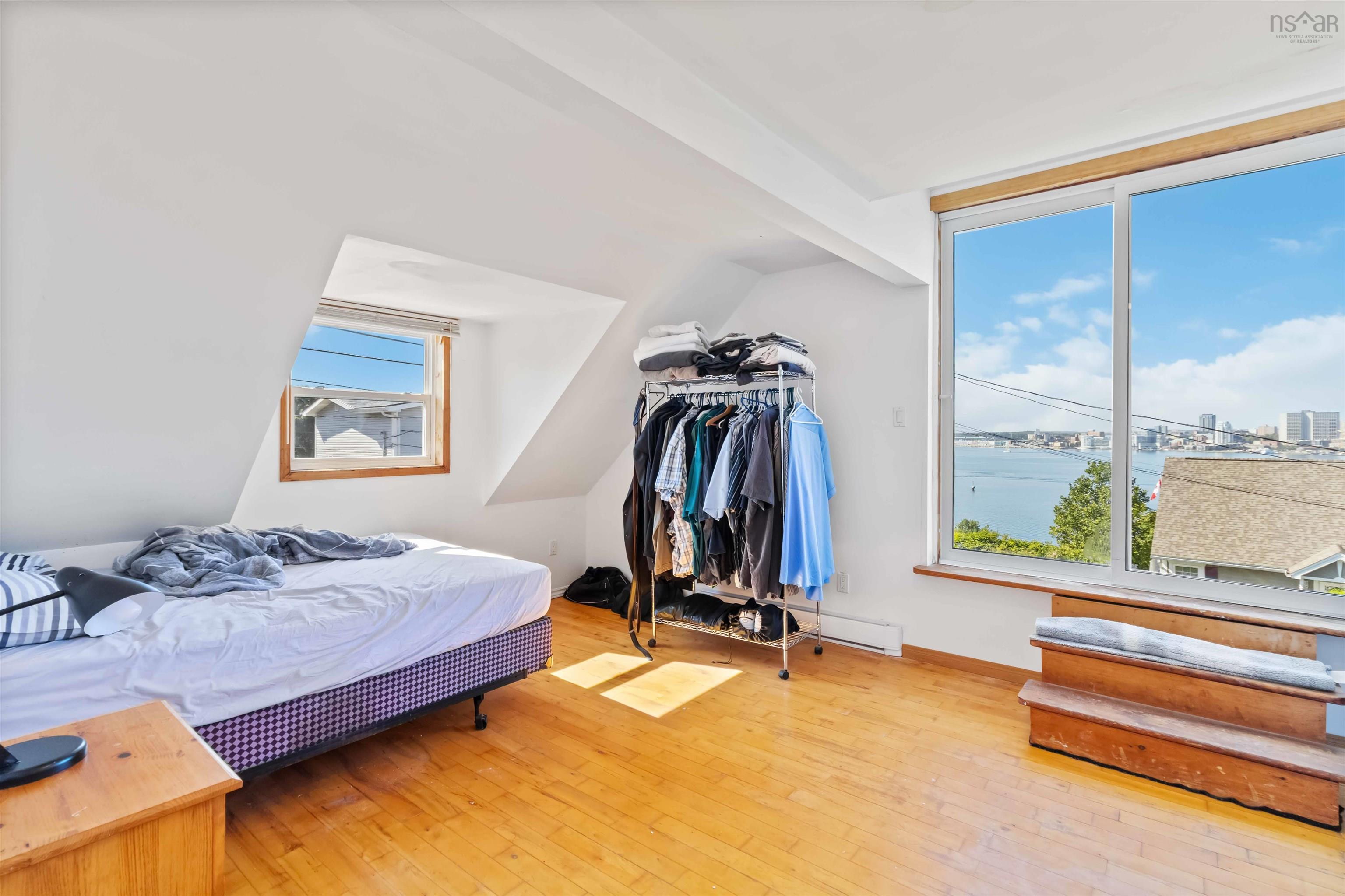 Bedroom featuring wood-type flooring and a water view