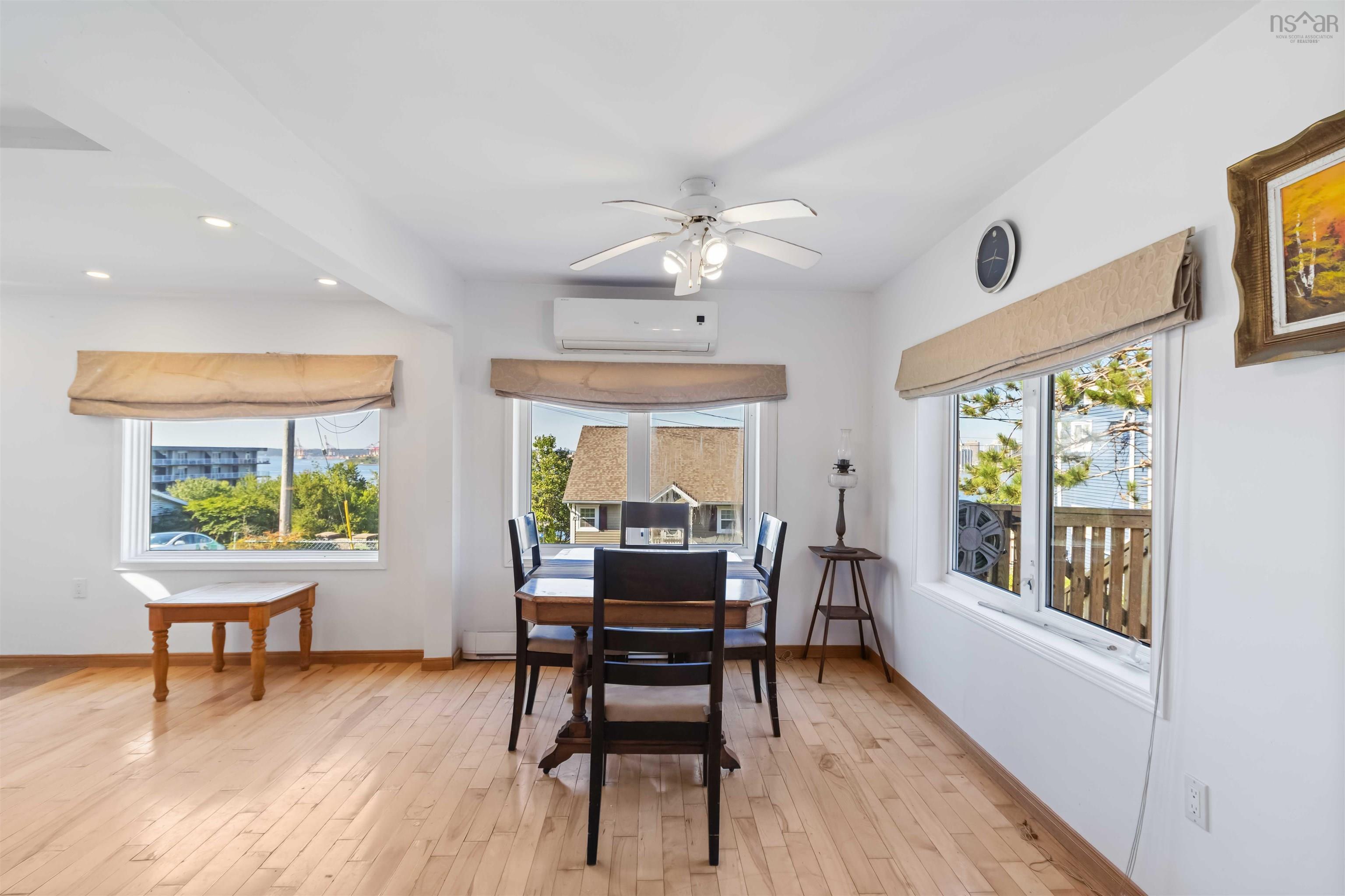 Dining area with light wood-type flooring, a ceiling fan, recessed lighting, and a wall mounted Heat Pump