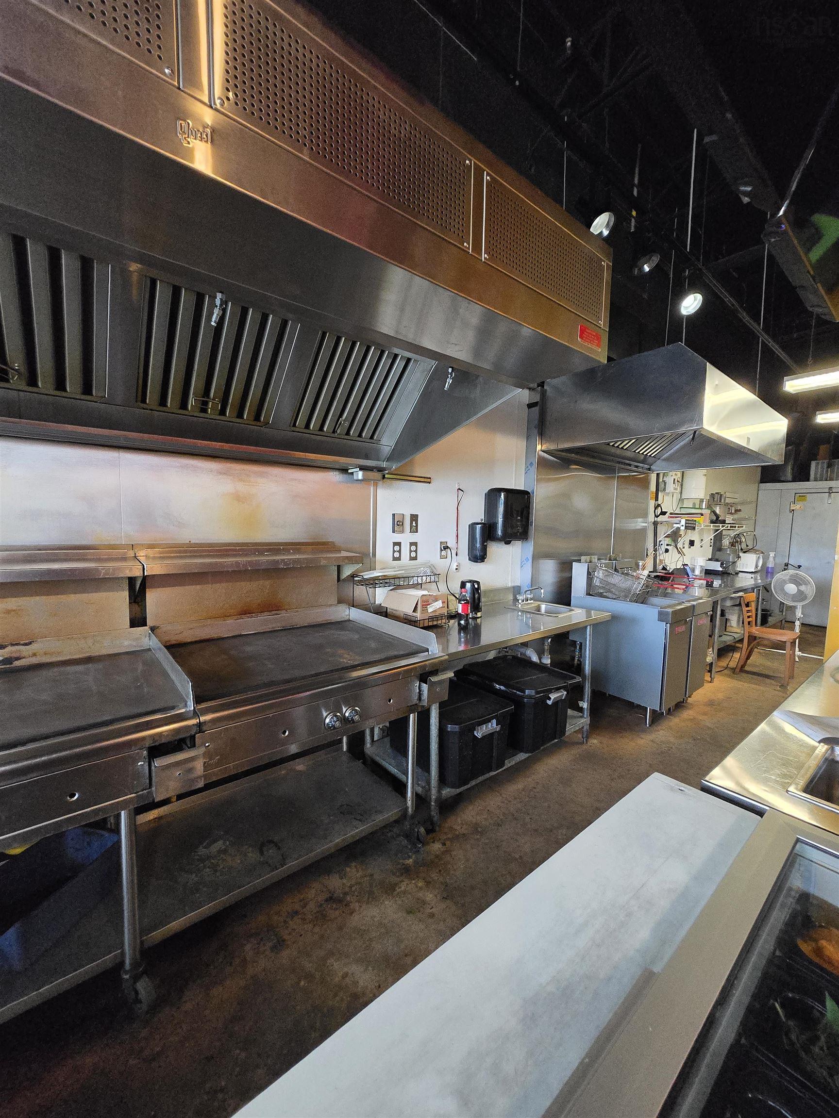 Kitchen with extractor fan and concrete flooring