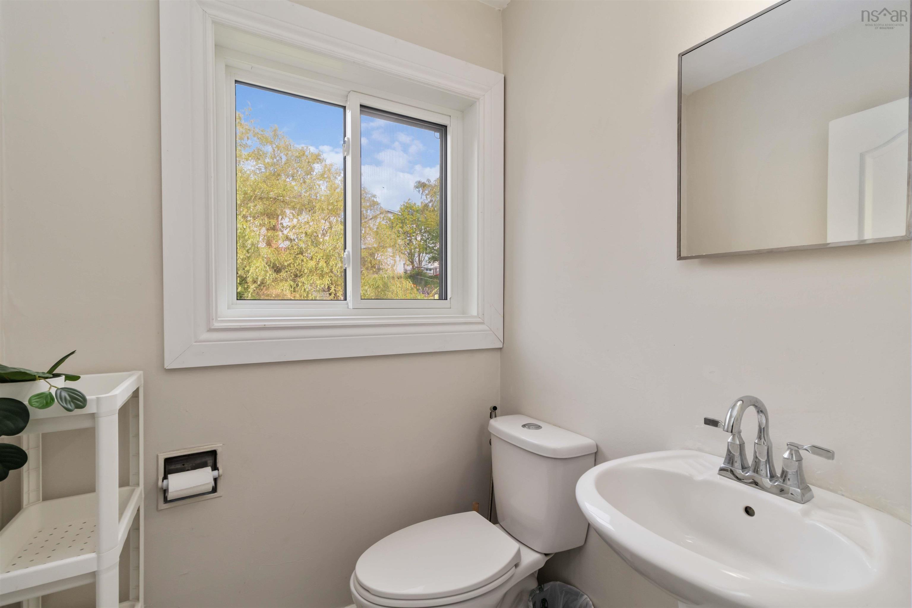 Half bath with a sink and toilet