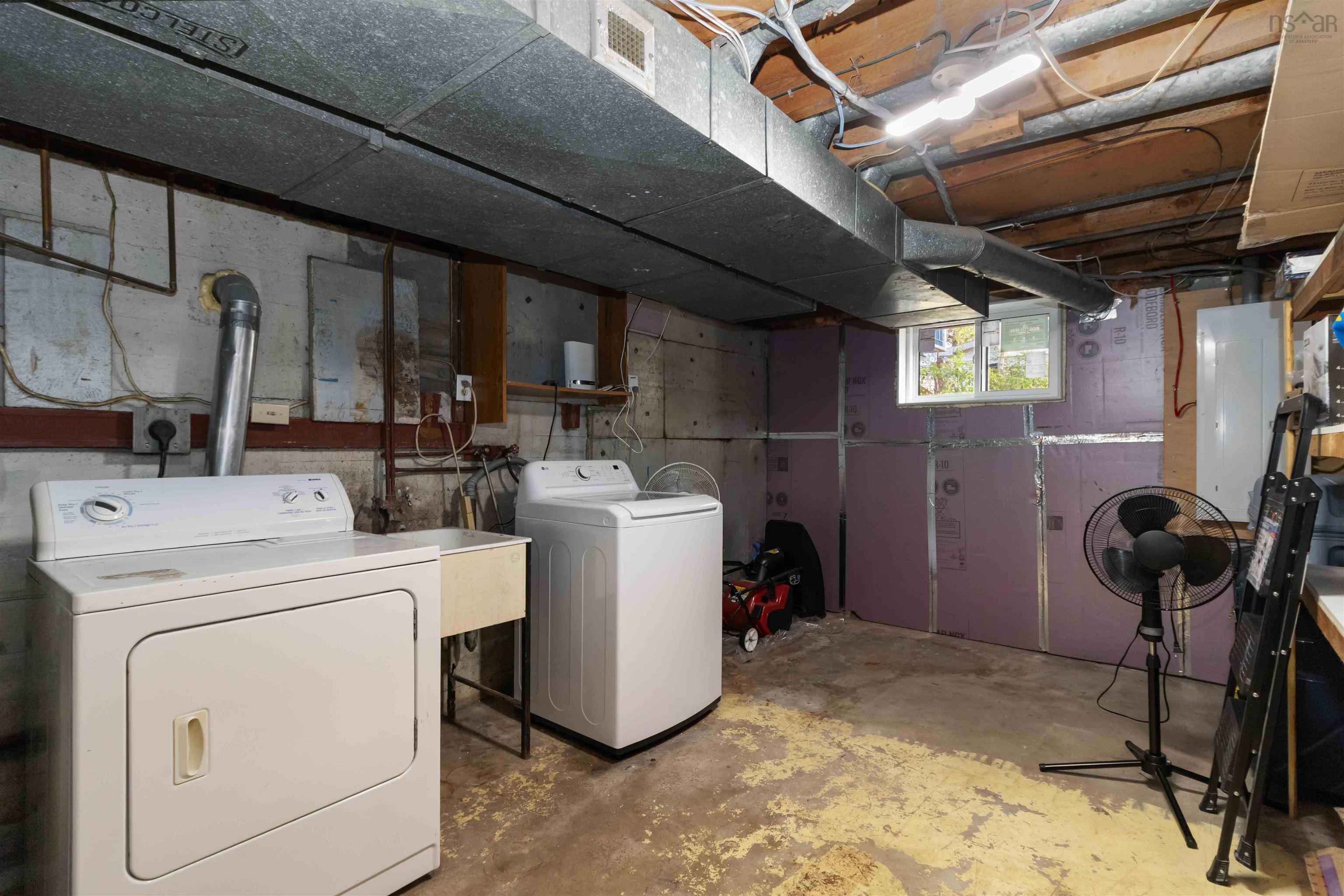 Basement with washer and dryer and a sink