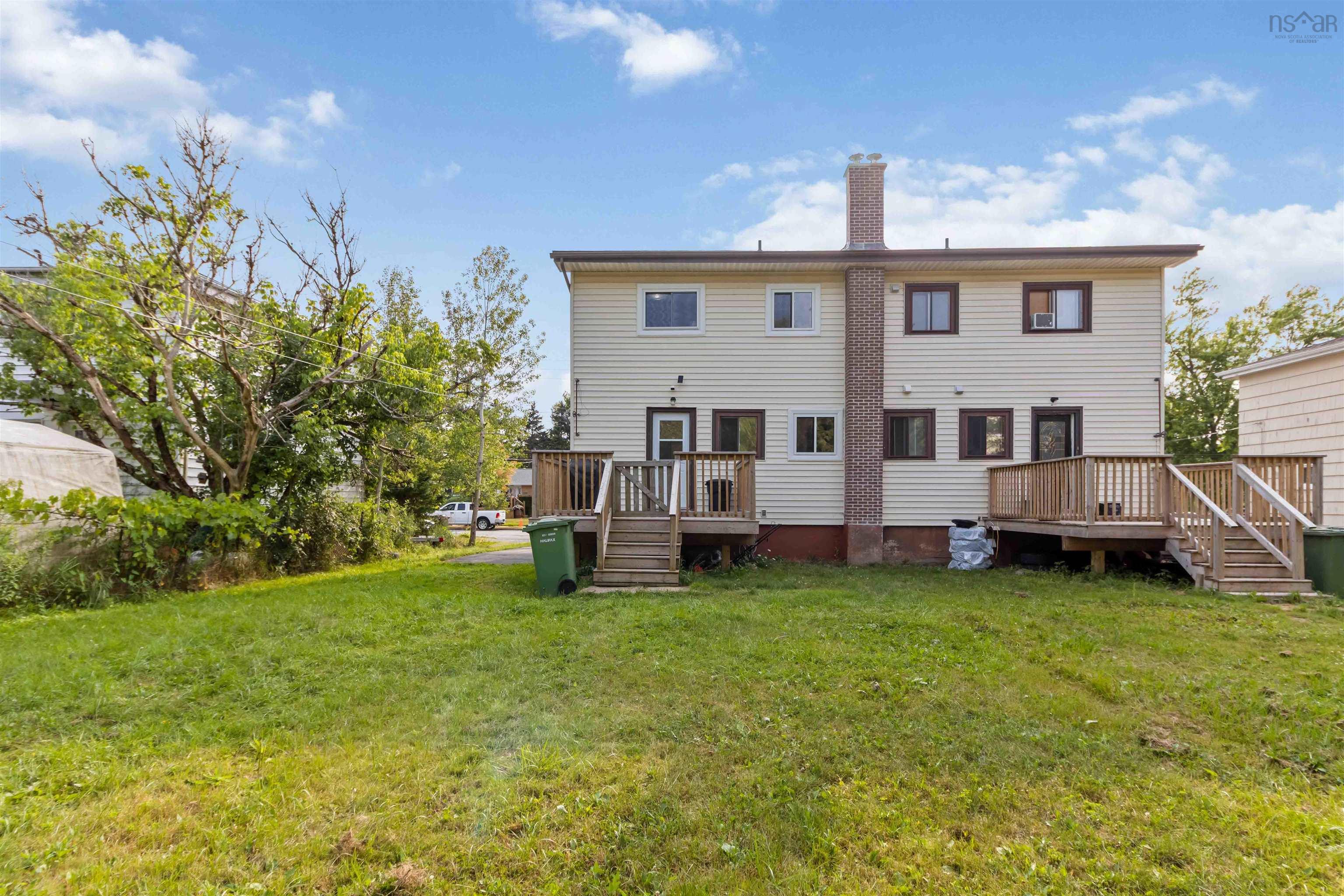 Rear view of house with a deck, and a yard