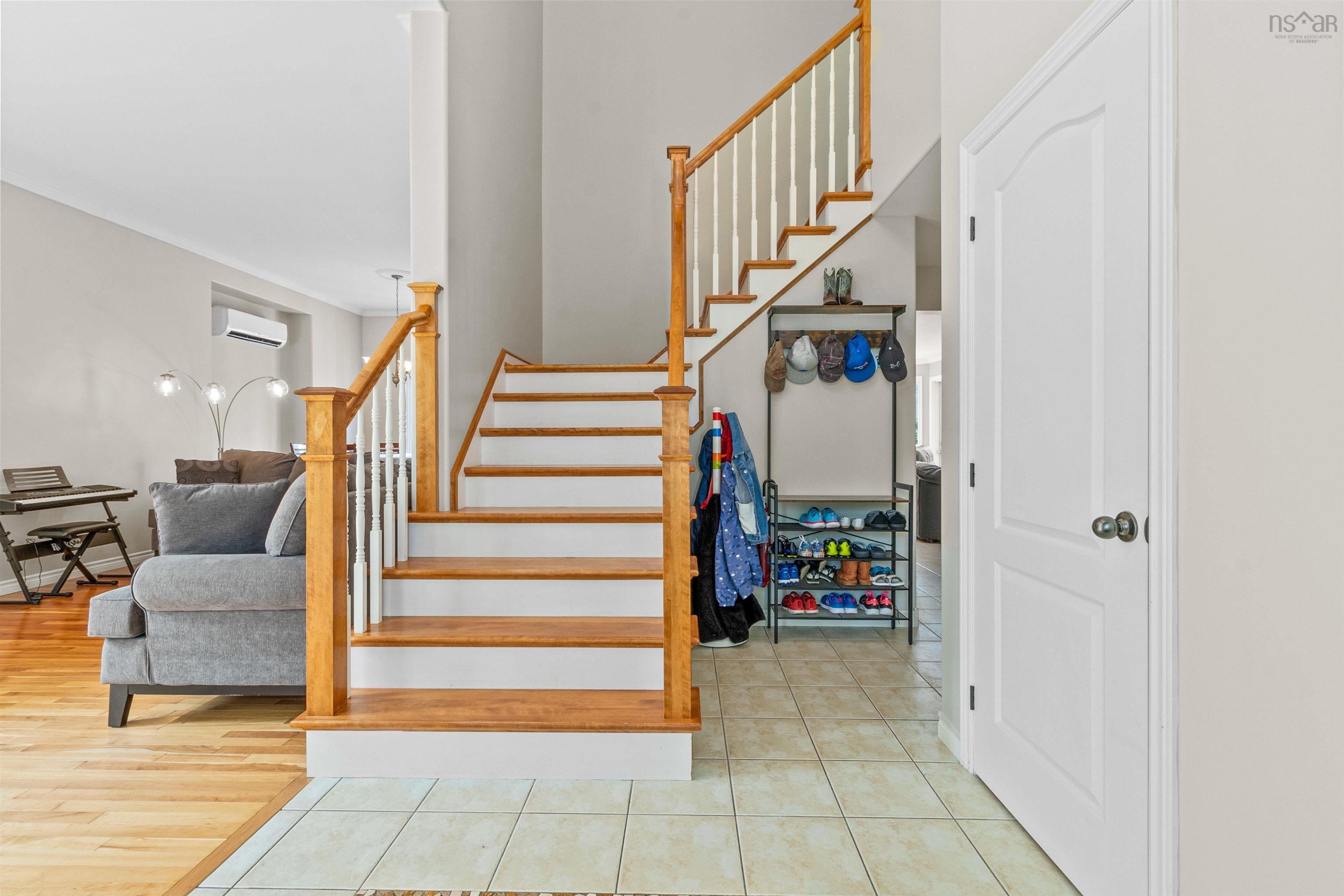 Stairs featuring tile patterned floors and a wall mounted AC