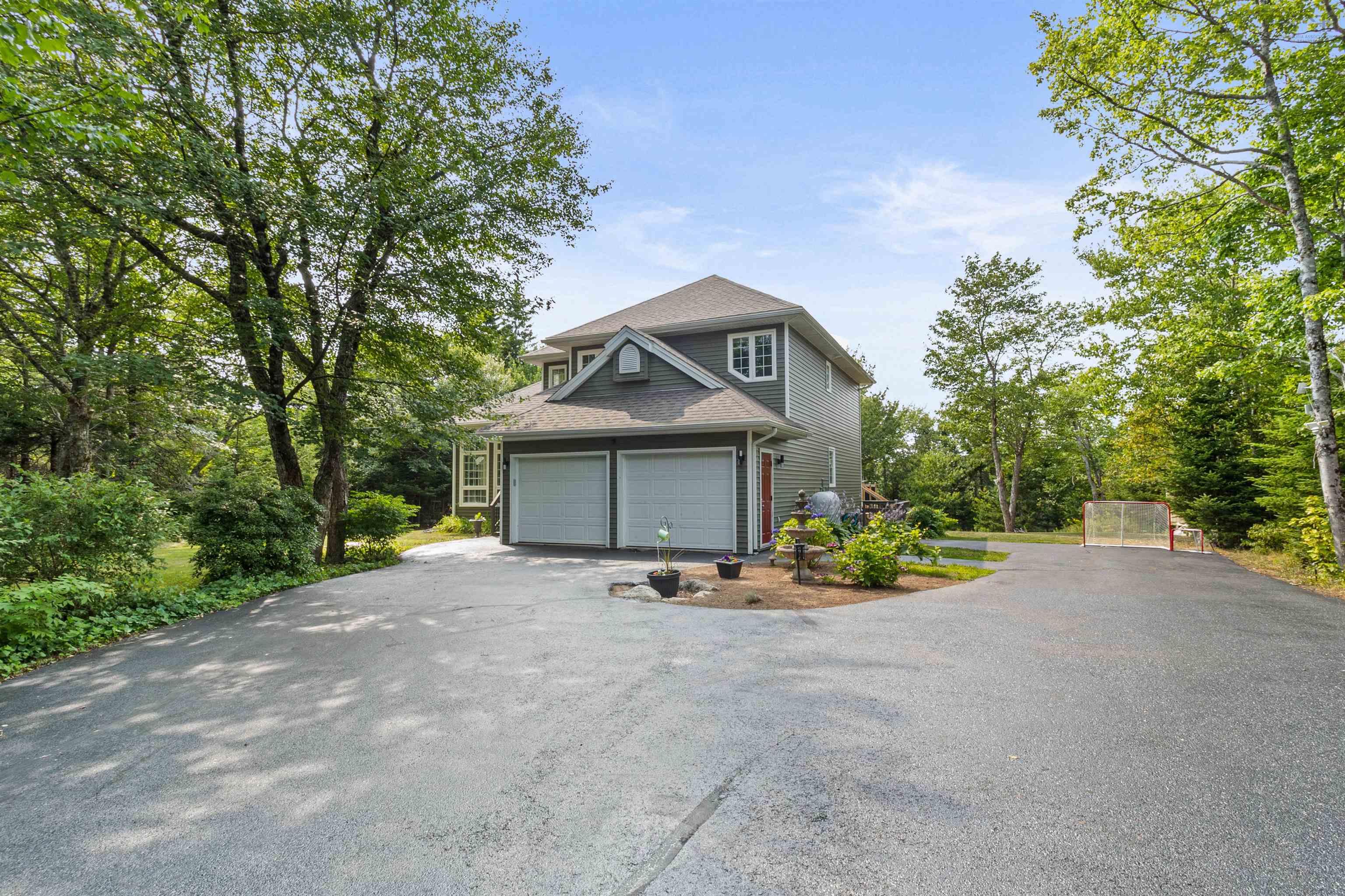 View of property exterior with driveway and a garage