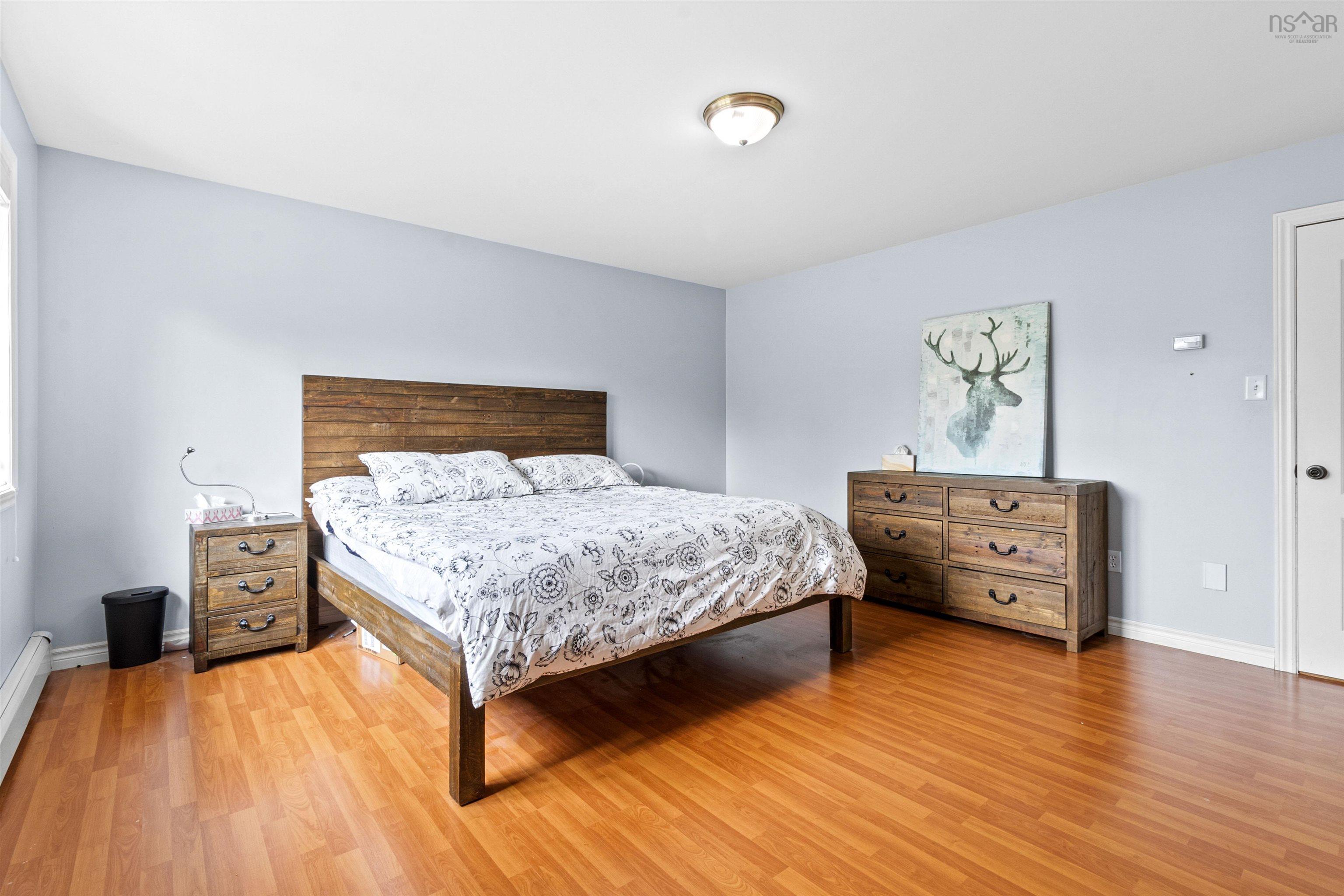 Bedroom featuring light wood-type flooring and baseboard heating