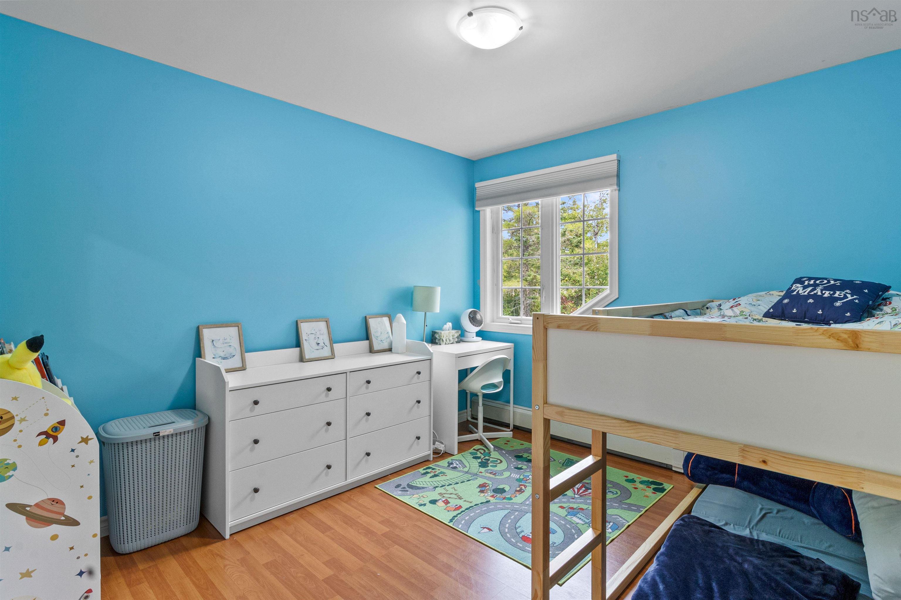 Bedroom with light wood-type flooring and baseboards