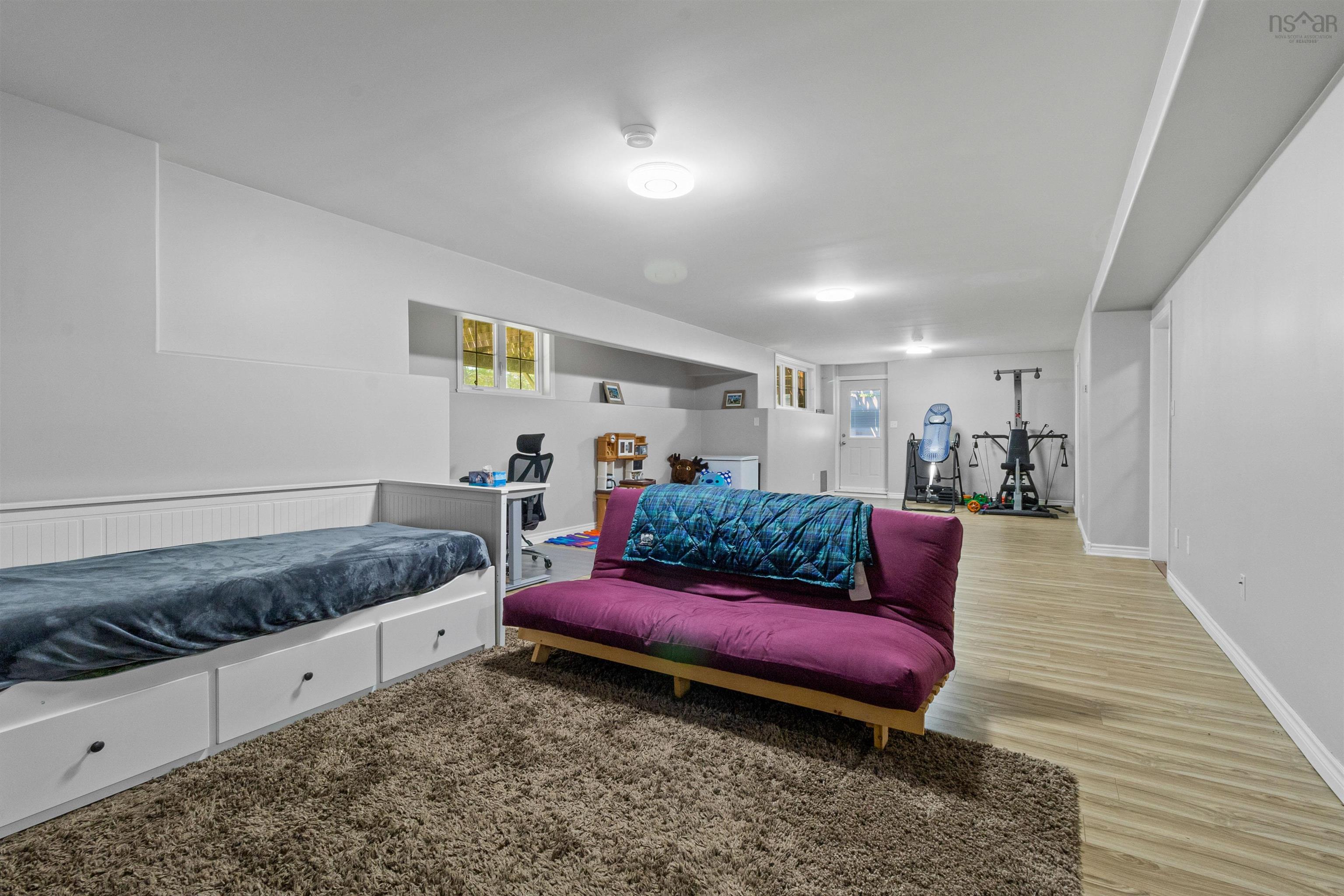 Living room with plenty of natural light and light wood-type flooring