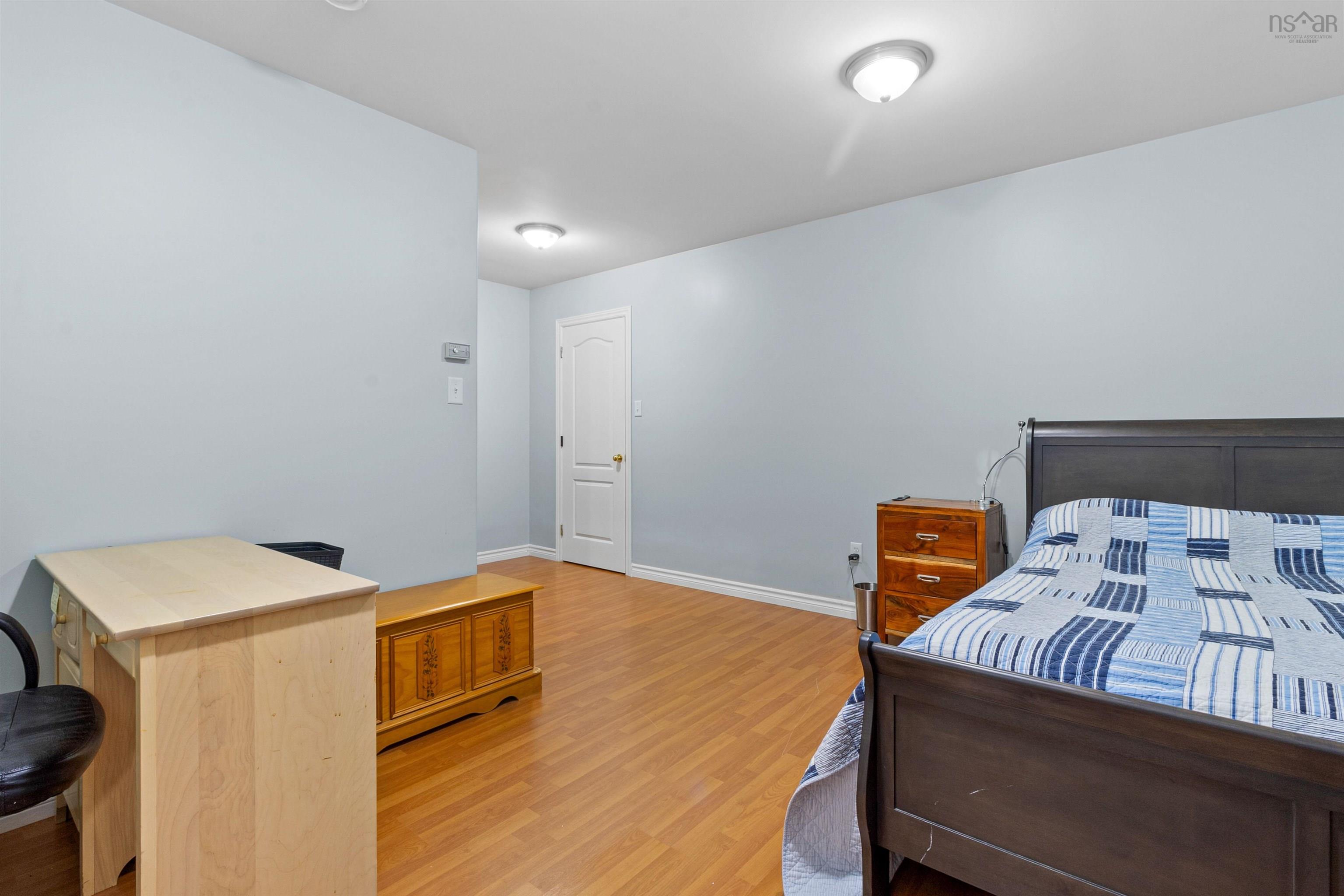 Bedroom featuring light wood-style flooring and baseboards
