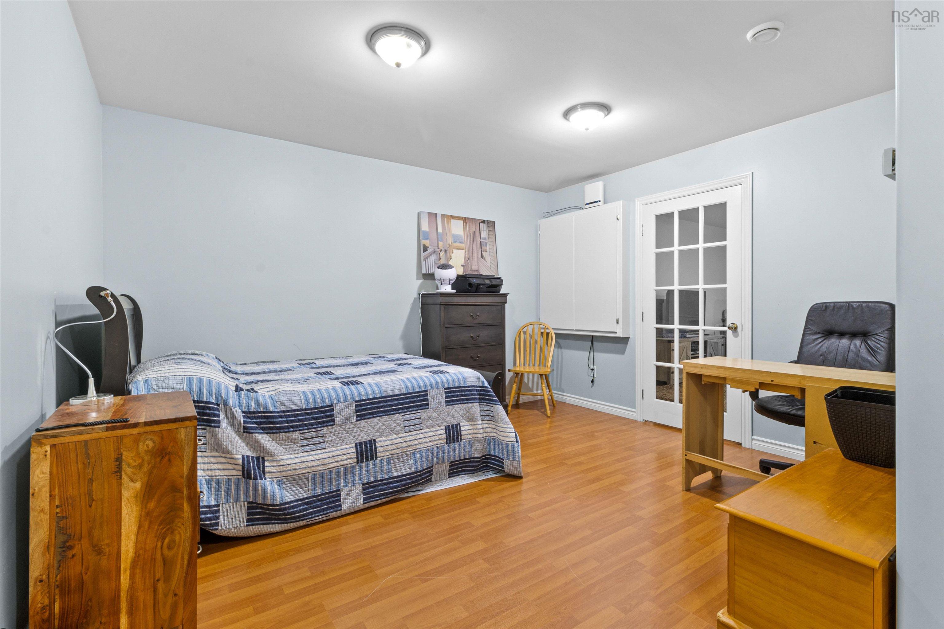 Bedroom featuring a desk and light wood-style flooring