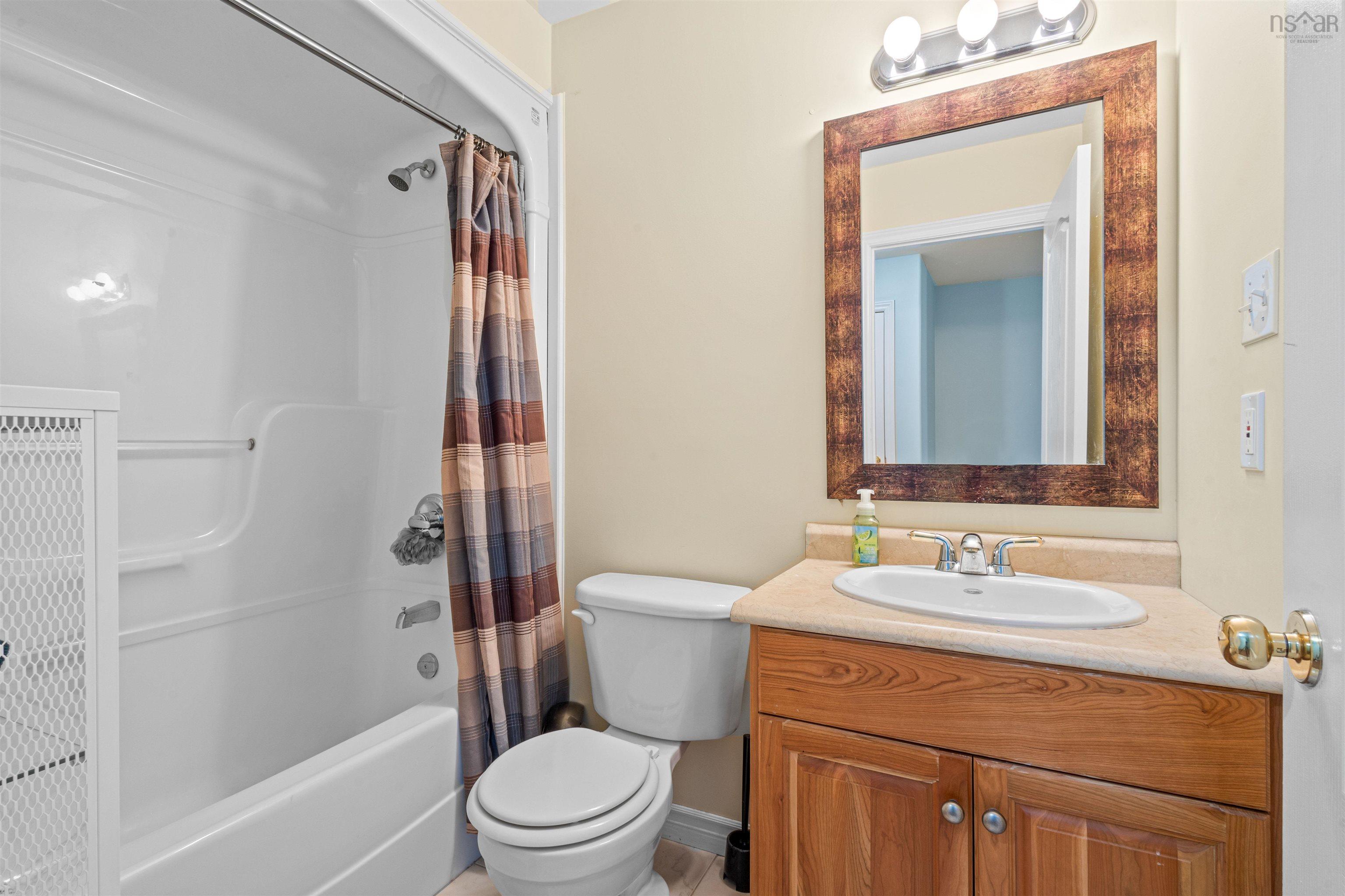 Full bath featuring shower / tub combo with curtain and vanity