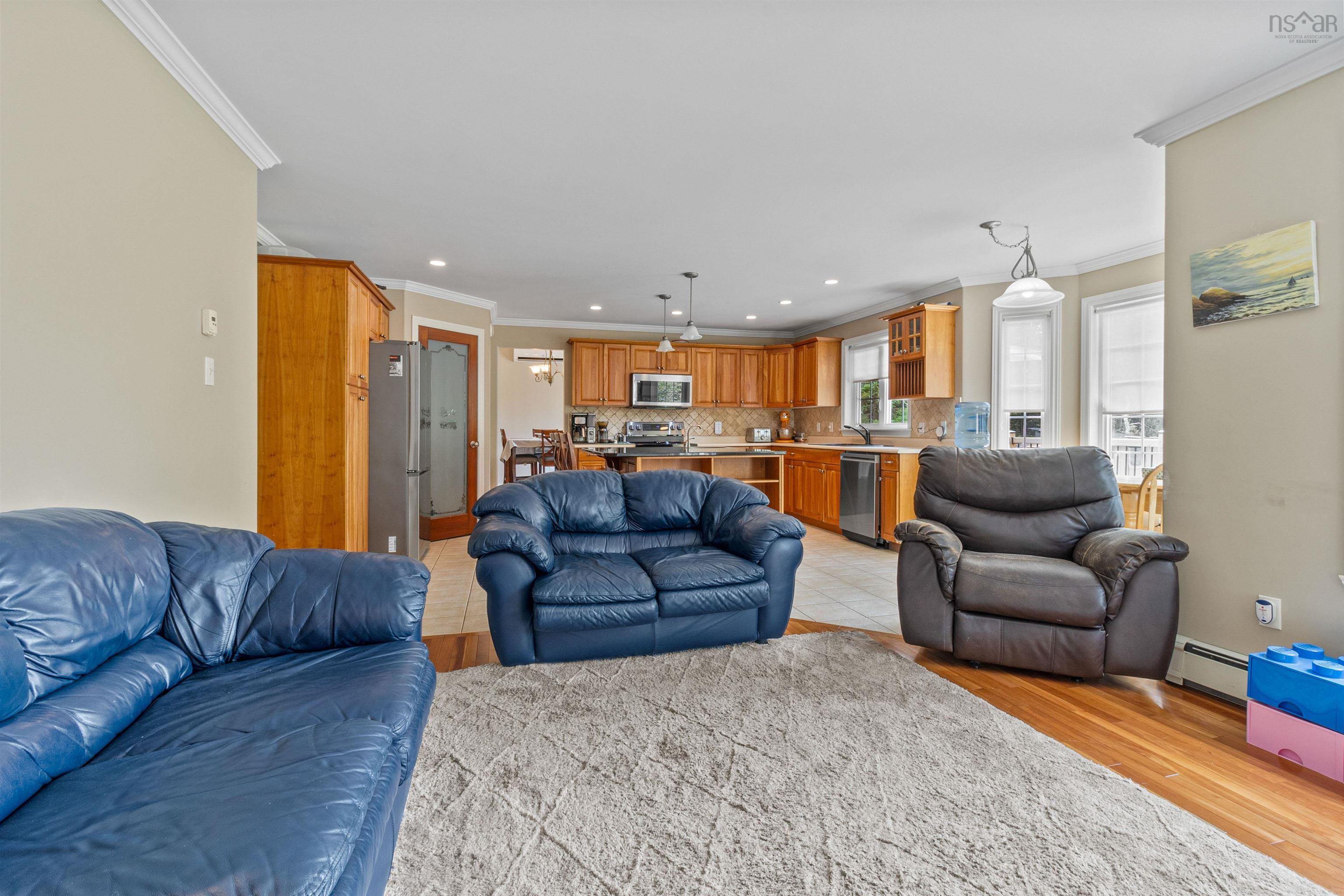 Living area featuring crown molding, light wood finished floors, recessed lighting, and a baseboard radiator