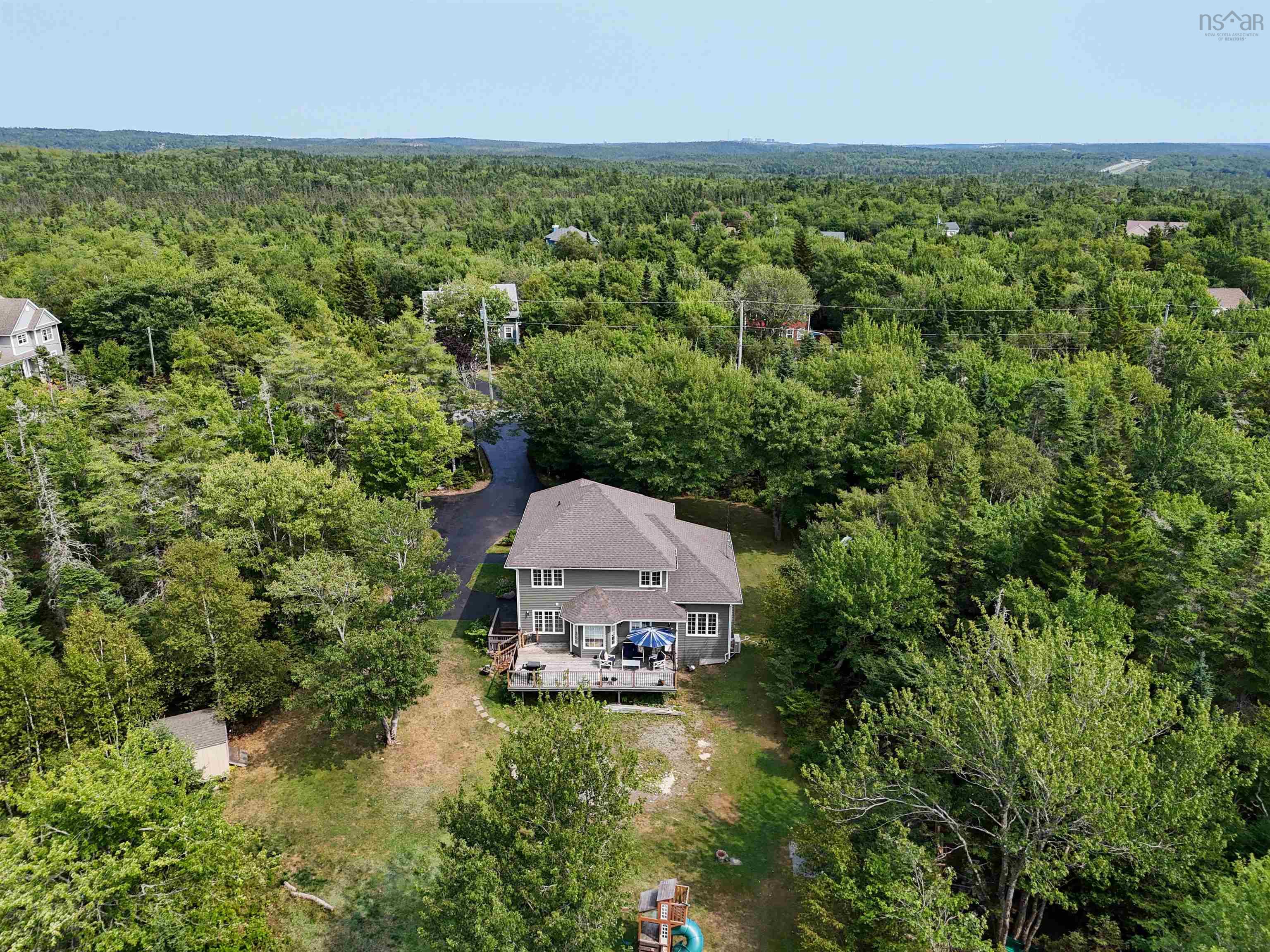 View of subject property with a forest