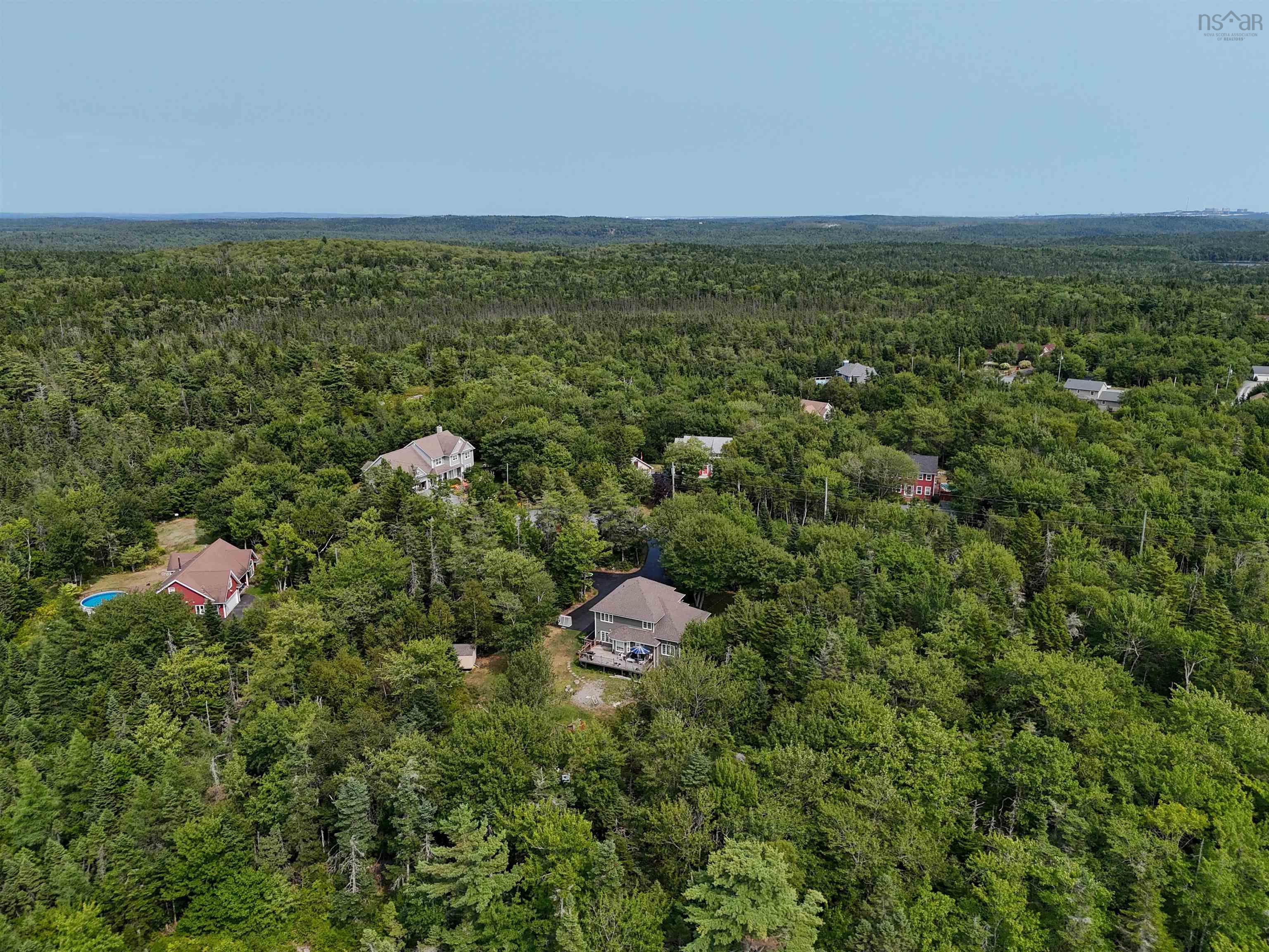 View of property location featuring a heavily wooded area