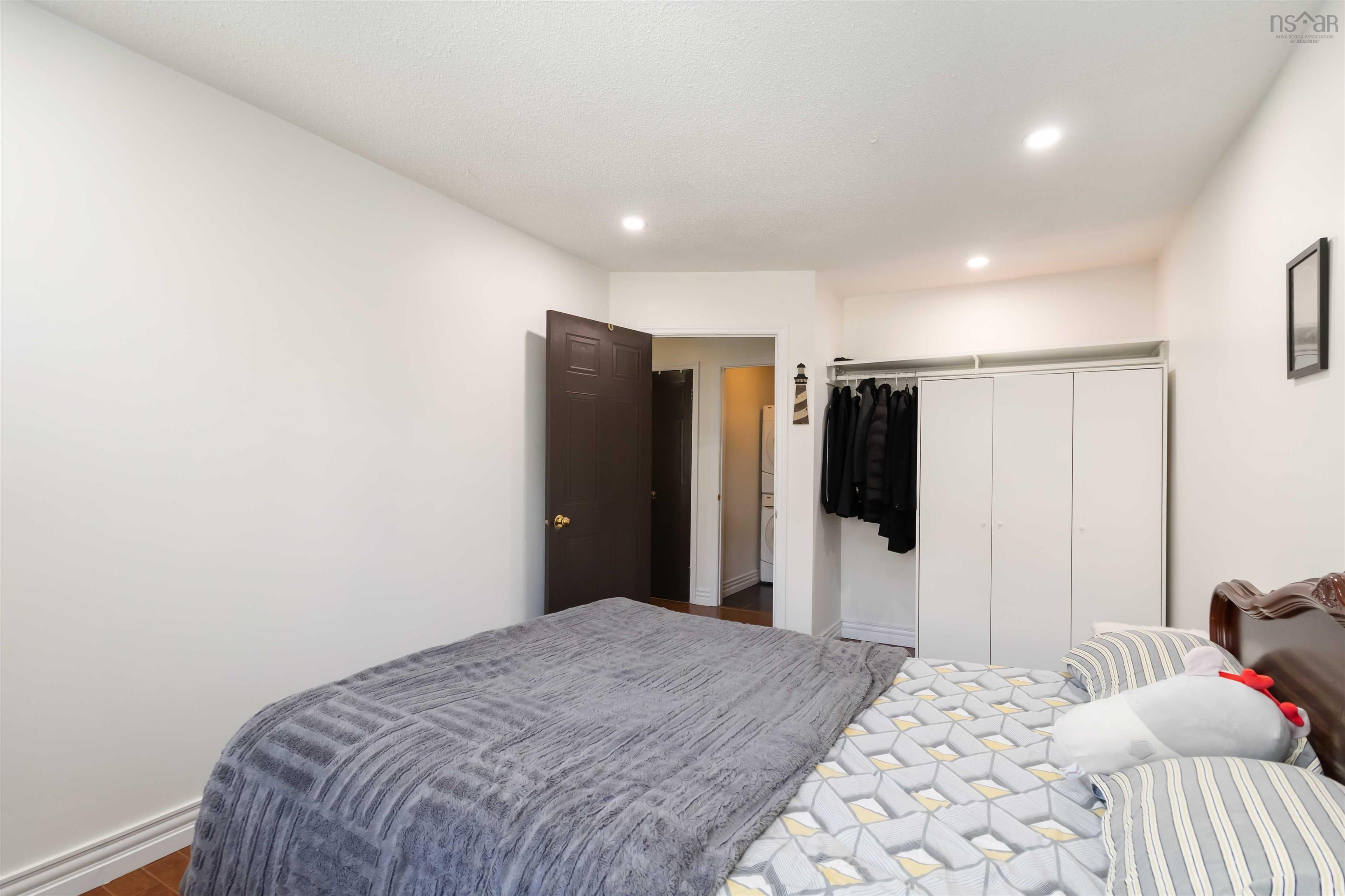 Bedroom featuring a closet, recessed lighting, and wood finished floors