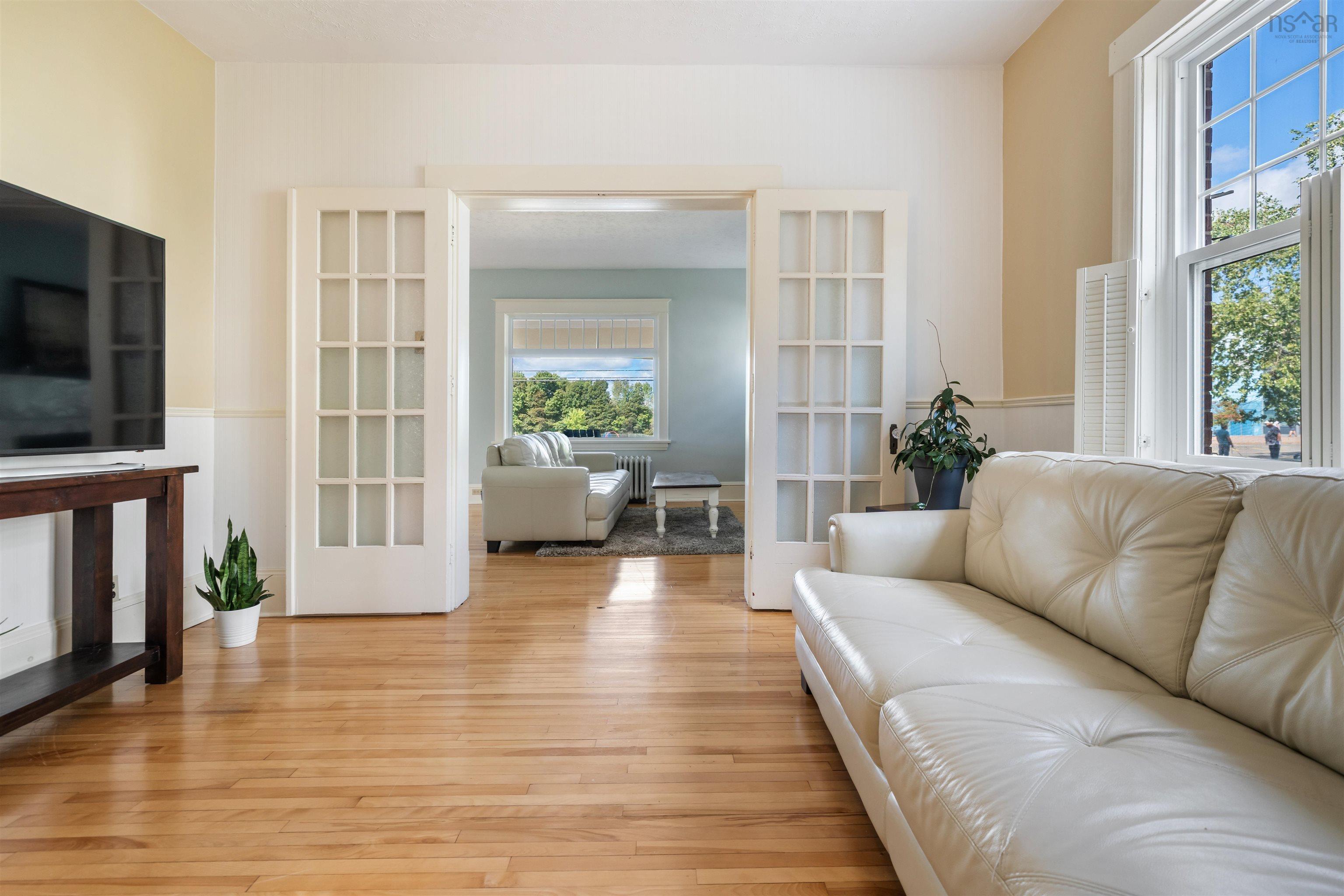 Living room featuring hardwood / wood-style flooring, french doors, and radiator