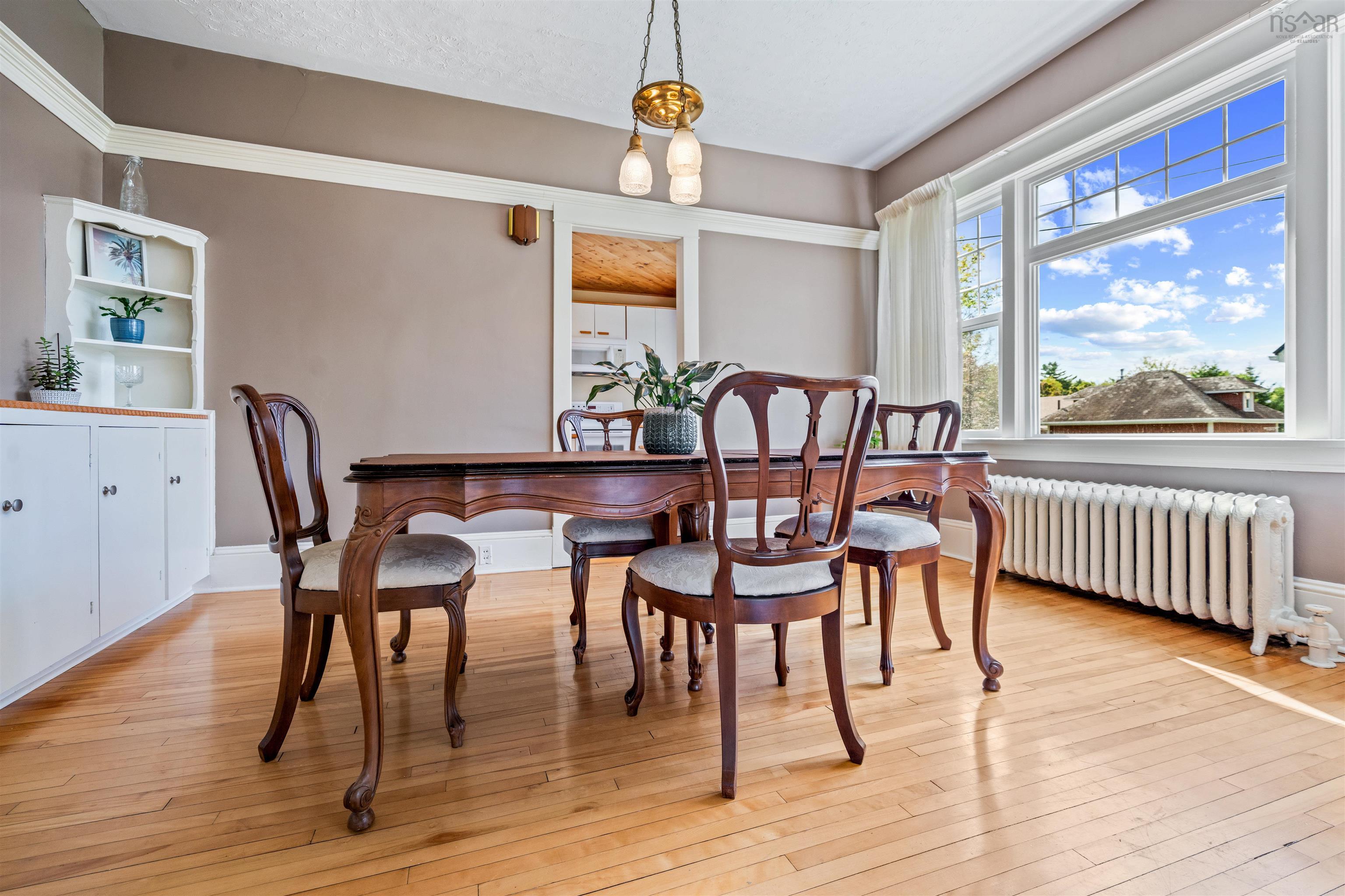 Dining room with radiator and light wood-type flooring