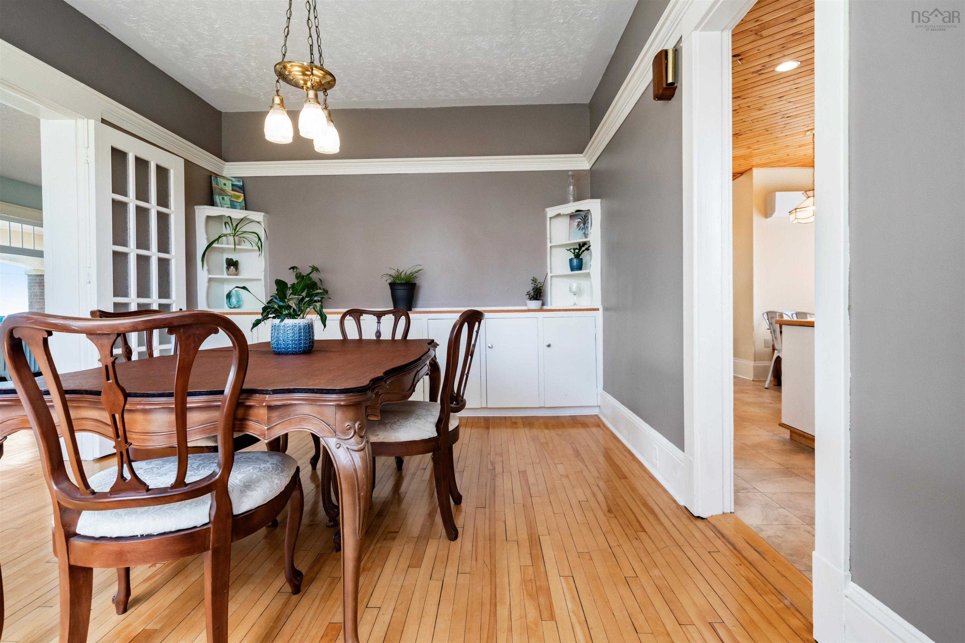 Dining space featuring light wood-style flooring, a chandelier, and a textured ceiling