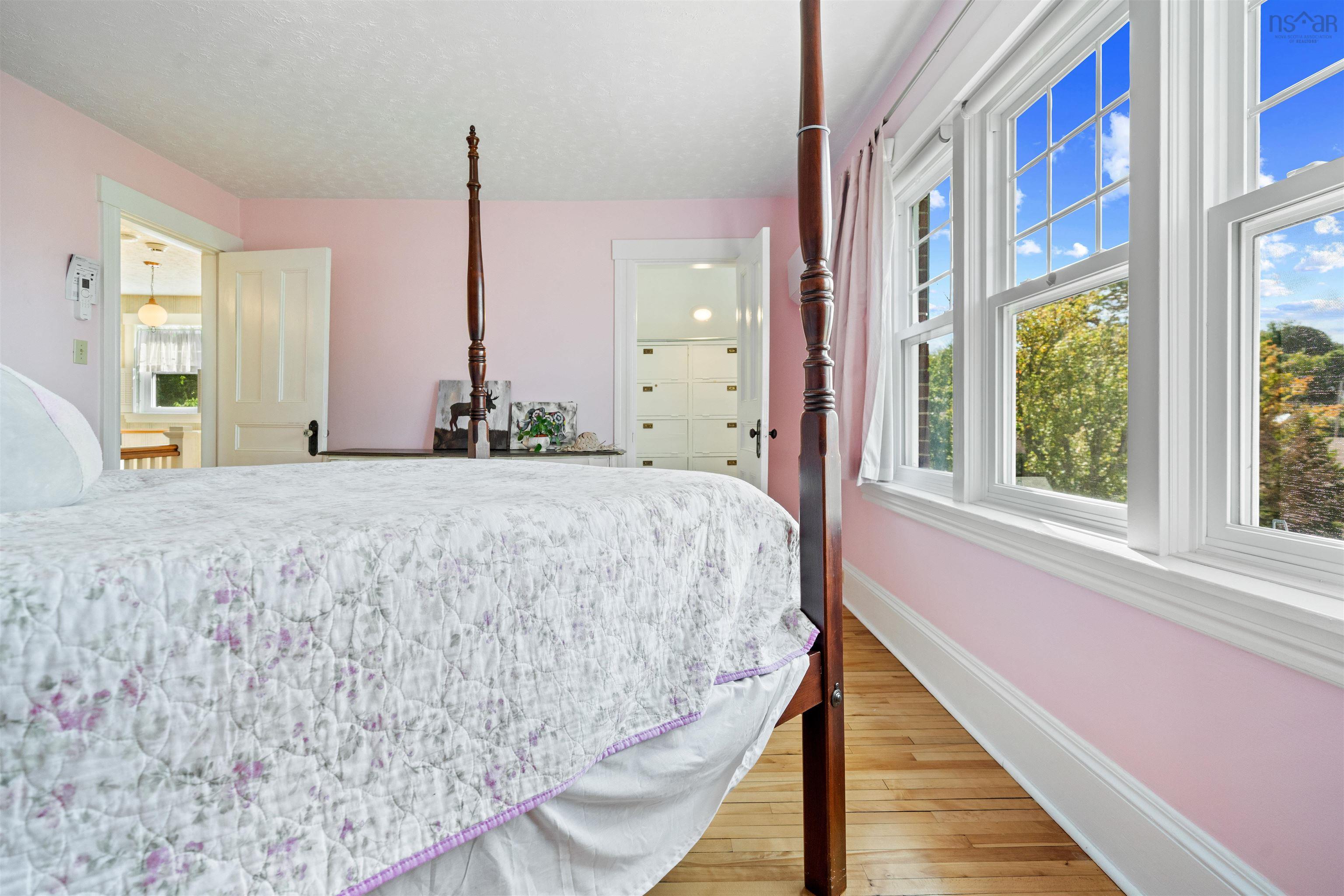 Bedroom with light wood-type flooring and baseboards